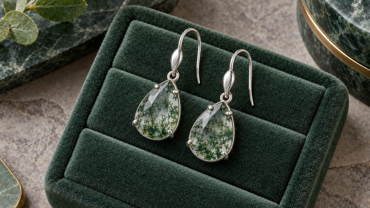 Illustrative silver-tone drop earrings with green-patterned stones on velvet; not verified depictions of listed products, moss agate or materials.