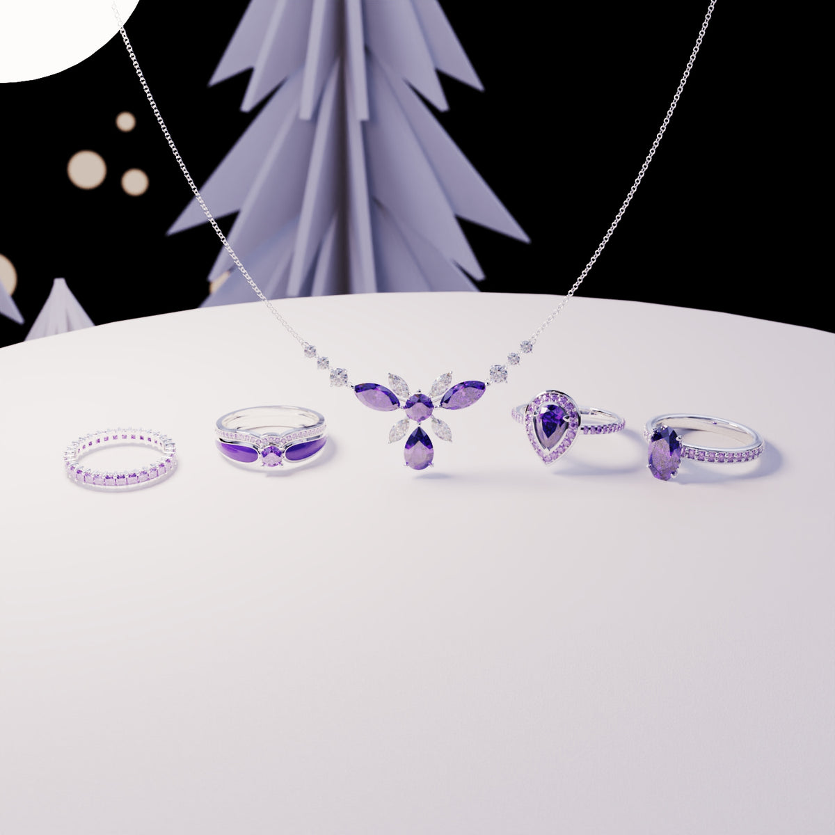 Silver-toned necklace and four rings with purple gemstones arranged on a white display