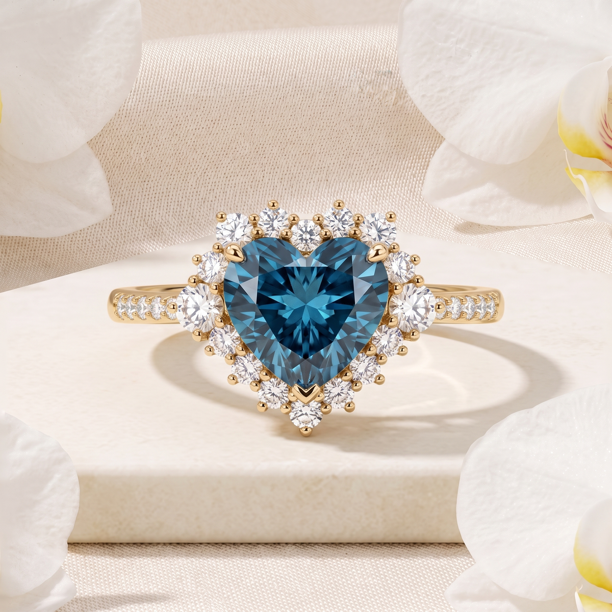 Front view of a yellow gold halo ring featuring a heart-cut teal blue moissanite center stone.