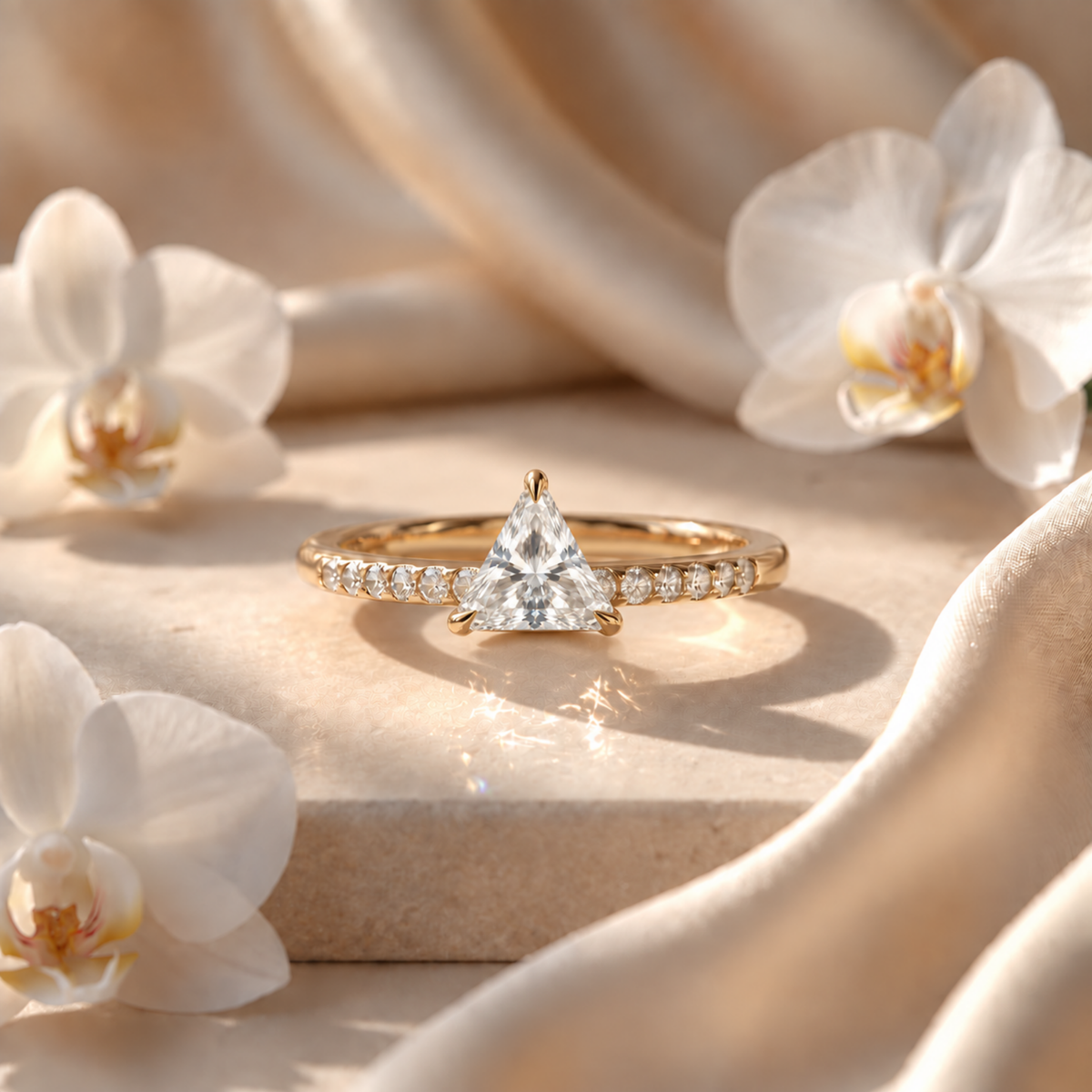 Yellow gold engagement ring featuring a trillion-cut moissanite center stone and a pave-set band.