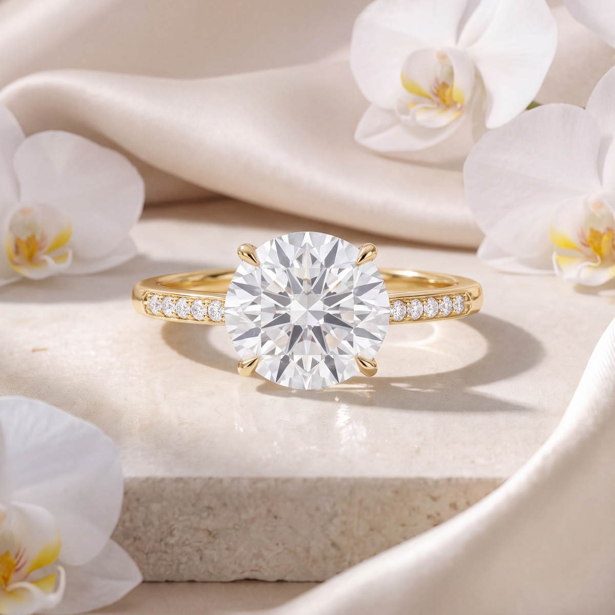 Front view of a round moissanite engagement ring in yellow gold with a pavé-set band.