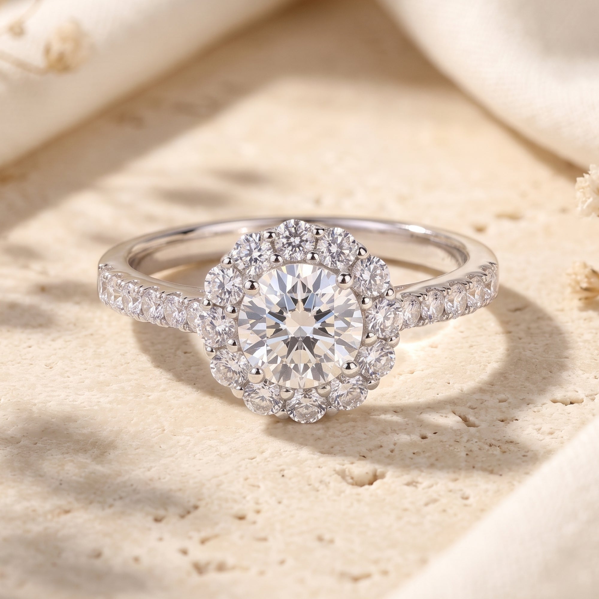 S925 sterling silver Aurora Bloom floral halo promise ring with a round-cut center stone on a stone surface.