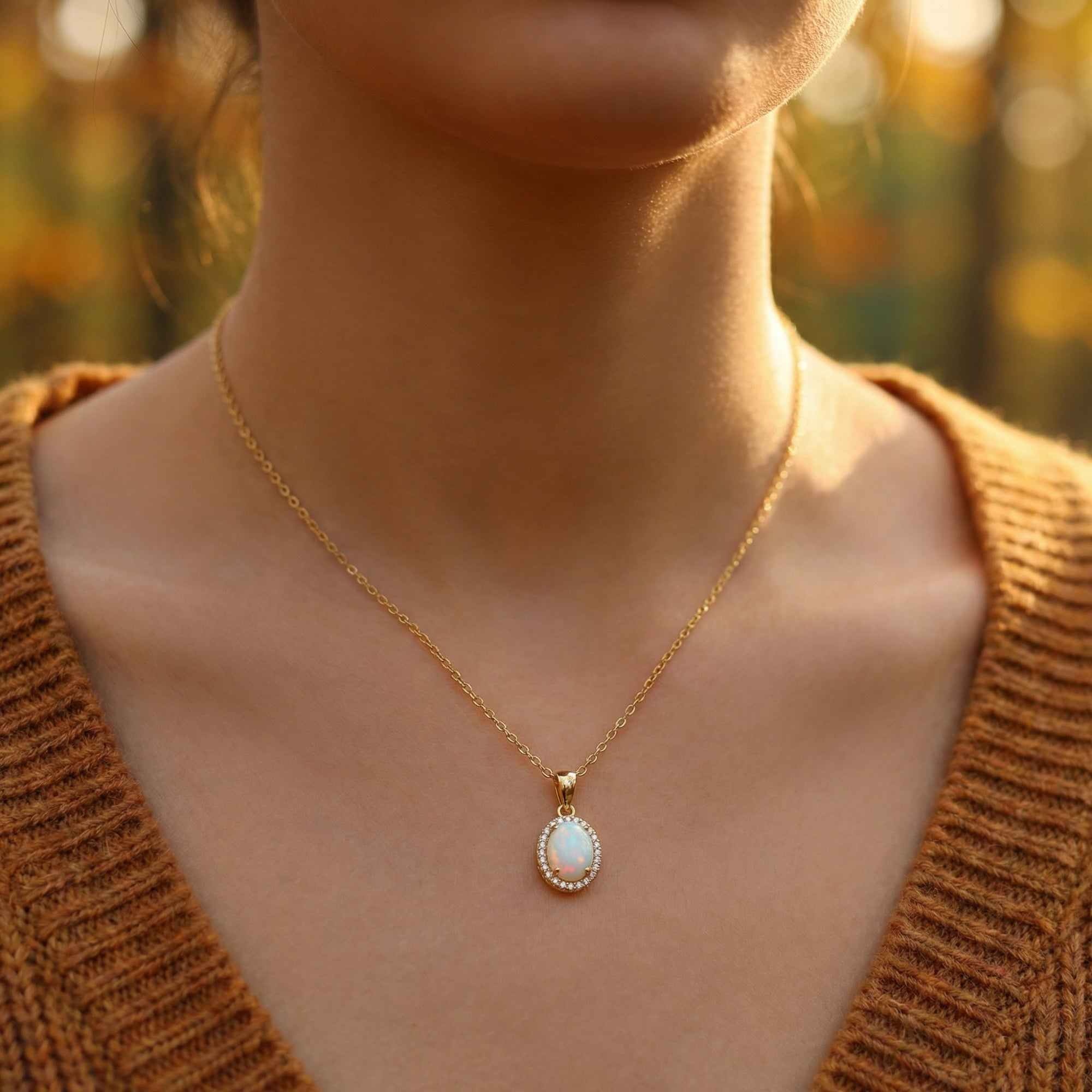 Model wearing the Liora gold-tone S925 silver necklace featuring a minimalist oval cut white opal pendant.