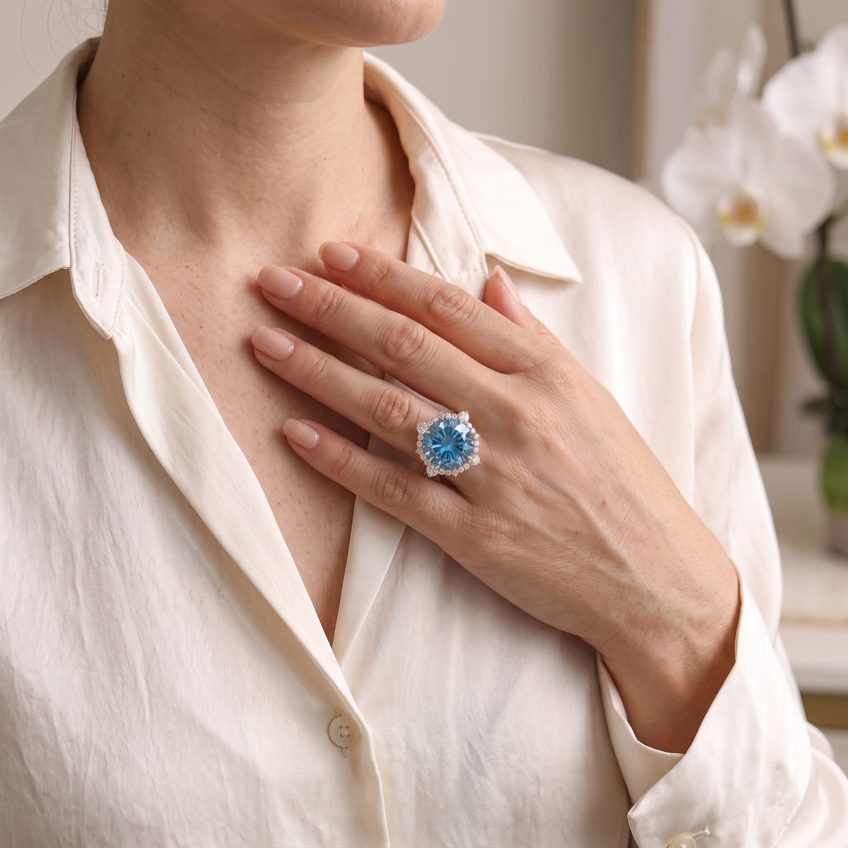 A woman wearing the rose gold blue moissanite halo ring on her finger.