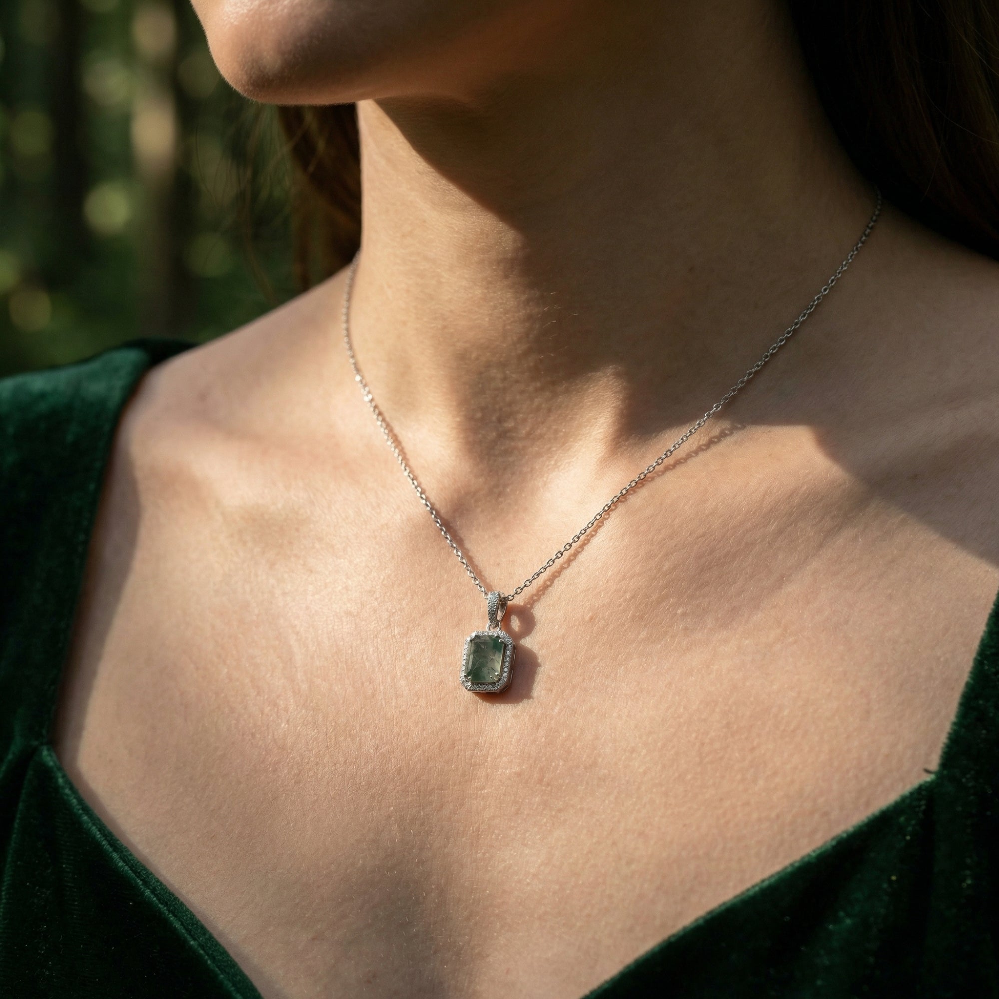Model wearing the rectangular moss agate pendant necklace in silver S925 sterling silver with a green velvet dress.