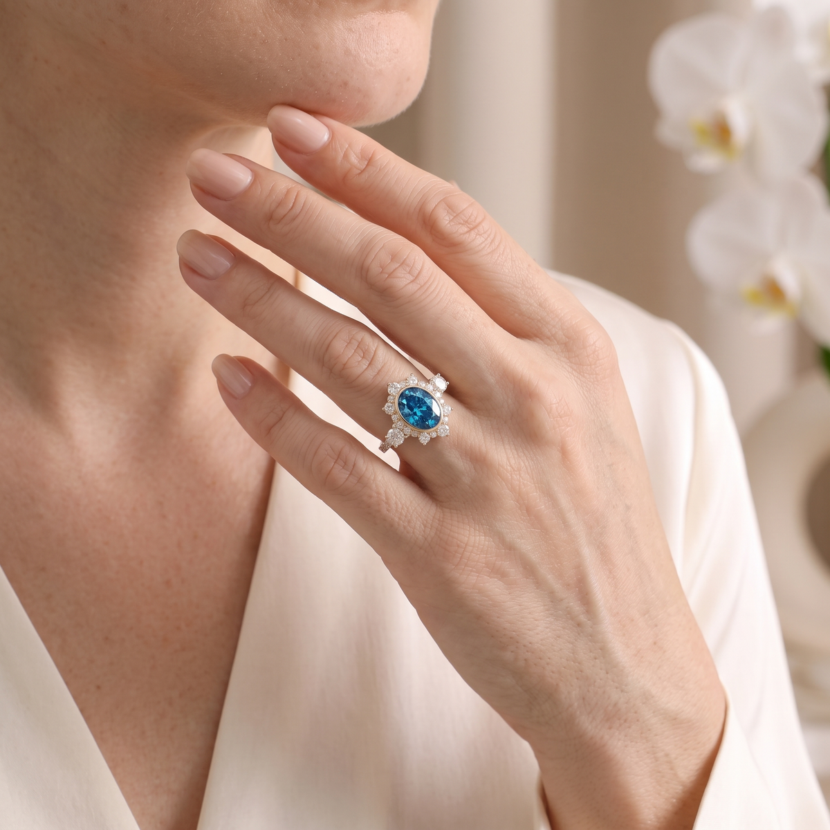 Model wearing the rose gold oval blue moissanite halo ring with her hand touching her chin.