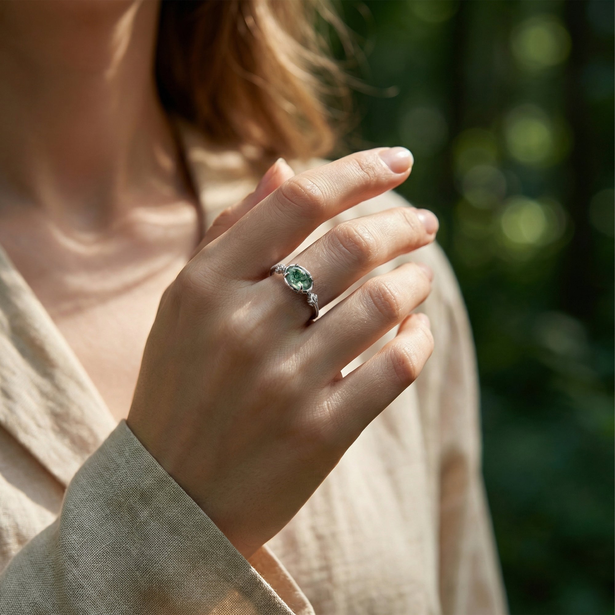 Model wearing the oval natural moss agate leaf engraved ring in S925 sterling silver on her finger.