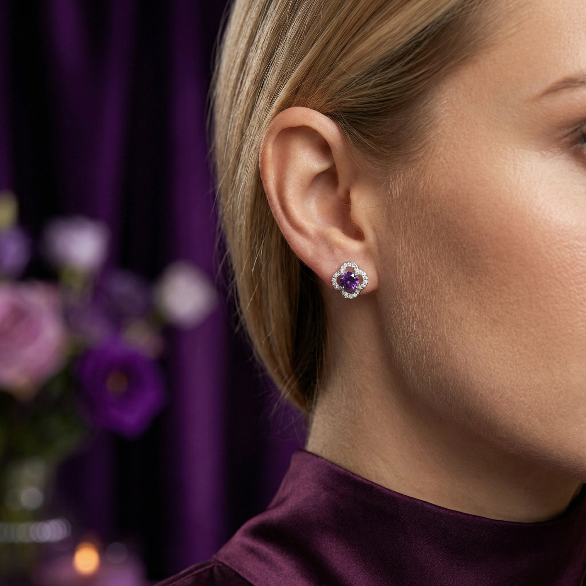 Model wearing a round cut natural amethyst stud earring in S925 sterling silver on her earlobe.