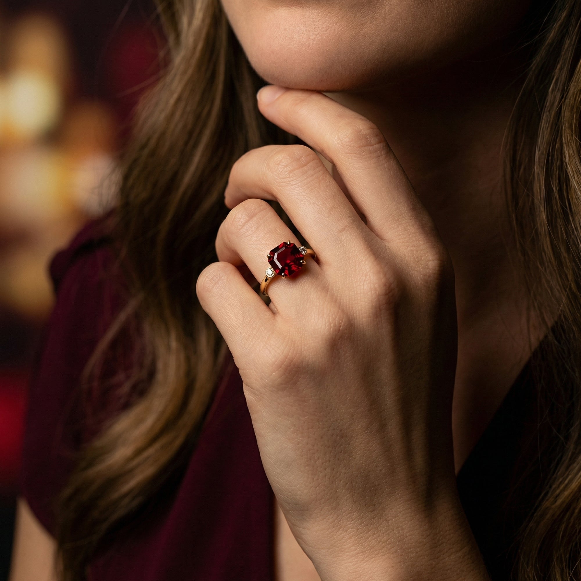 Woman wearing the 18K yellow gold Vanguard ring with a 3-carat octagon garnet on her finger.