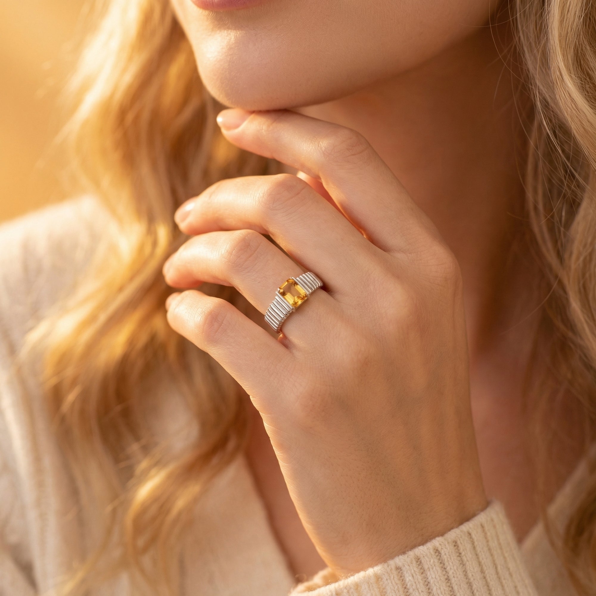 Emerald-cut natural citrine silver ring worn on a woman's hand, lifestyle portrait view.