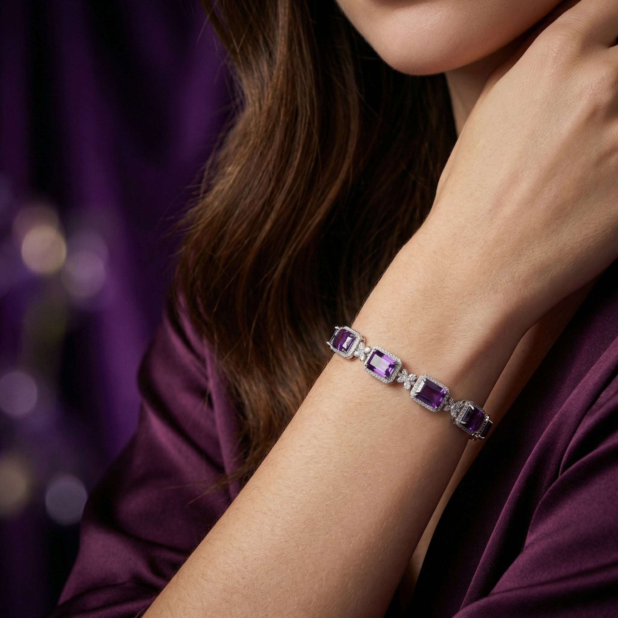 Square cut amethyst and S925 sterling silver bracelet worn on a woman's wrist against a purple background.