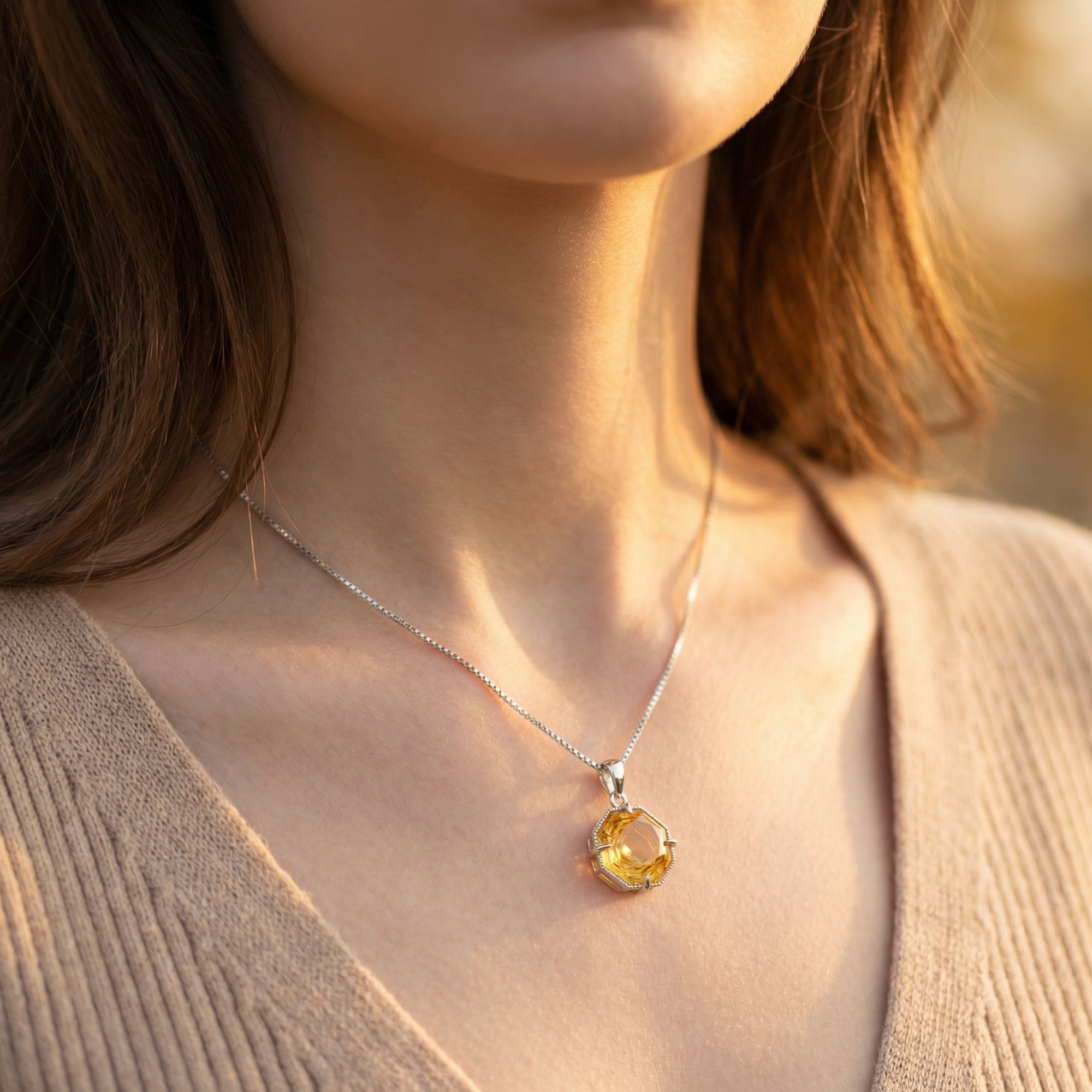 Lumielle octagon citrine necklace in white gold worn by a model, showing the pendant's scale and radiance.