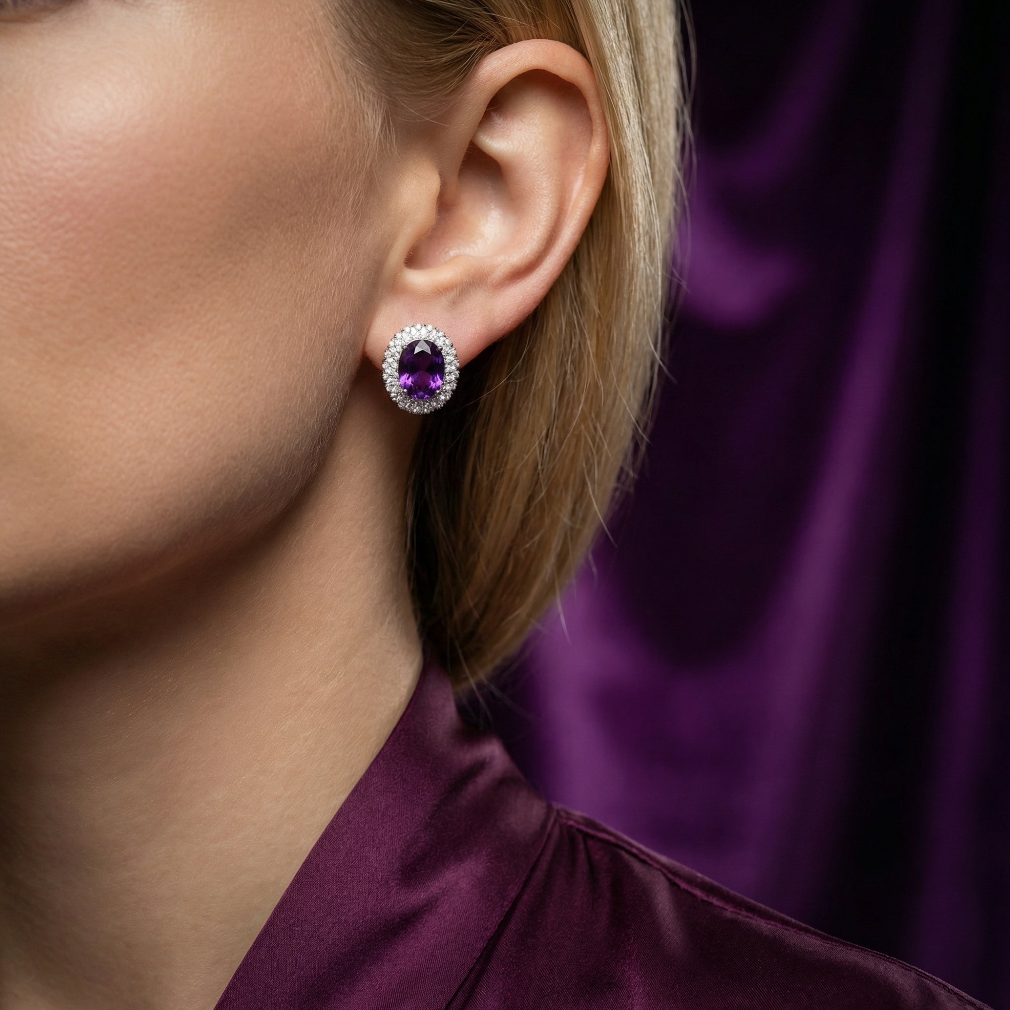 Woman wearing a large oval cut natural amethyst halo earring in sterling silver.