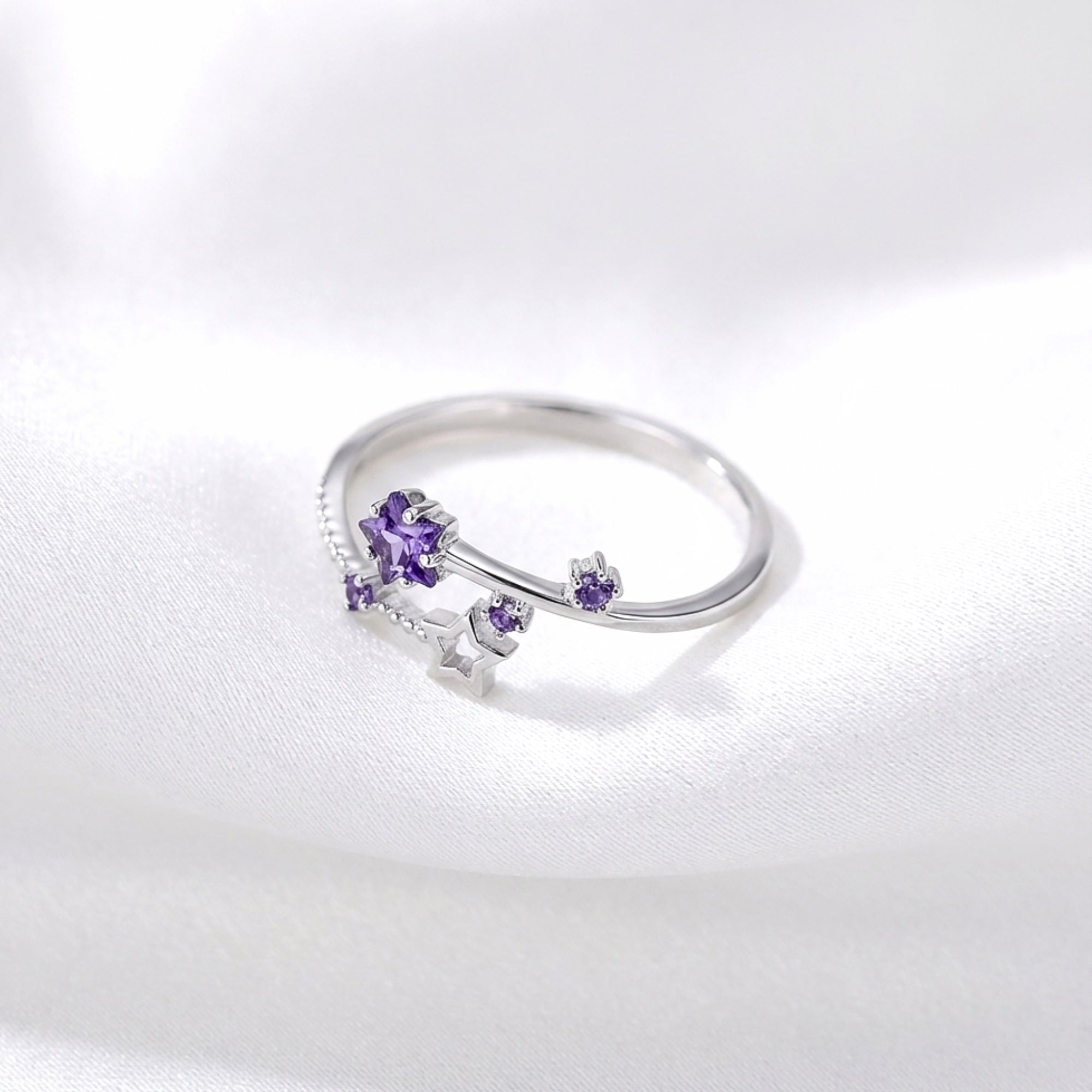 Top view of the adjustable S925 sterling silver Galaxia ring with star-cut purple simulated amethyst.
