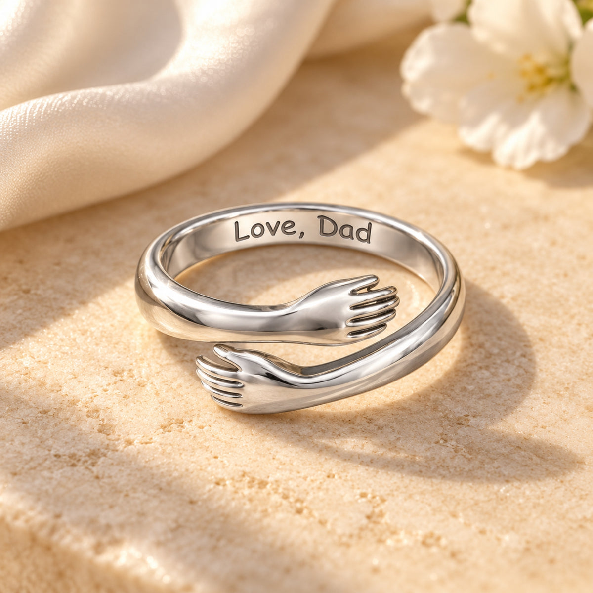 Silver-tone hug ring showing Love, Dad inside the band