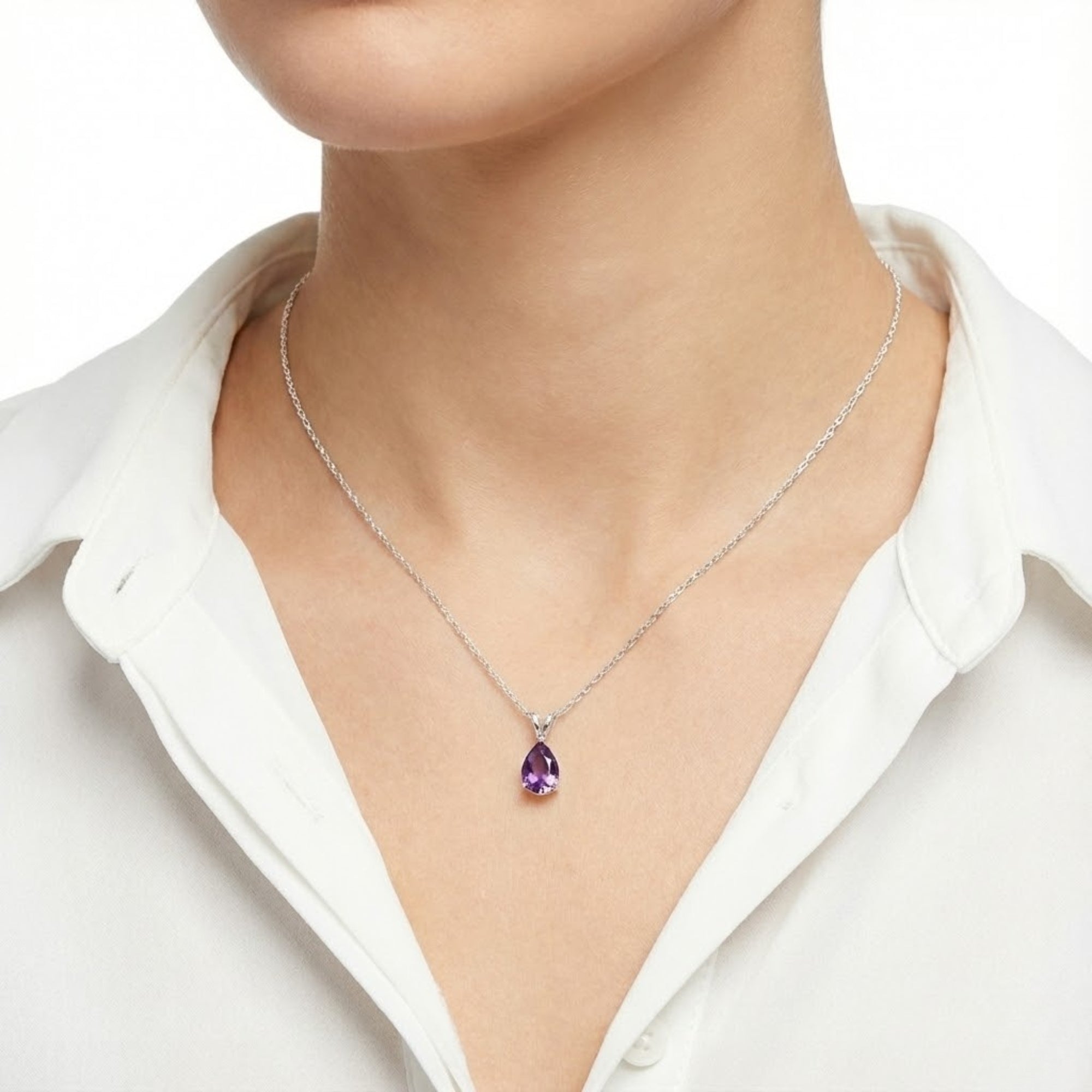 Woman wearing the Lucerne Drop purple moissanite necklace in sterling silver with a white shirt.