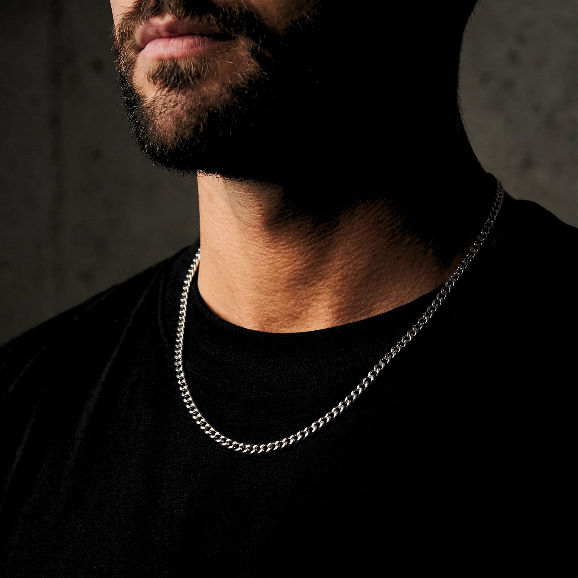 Men's 4mm silver Miami Cuban chain in stainless steel worn by a model to show neck fit and style.