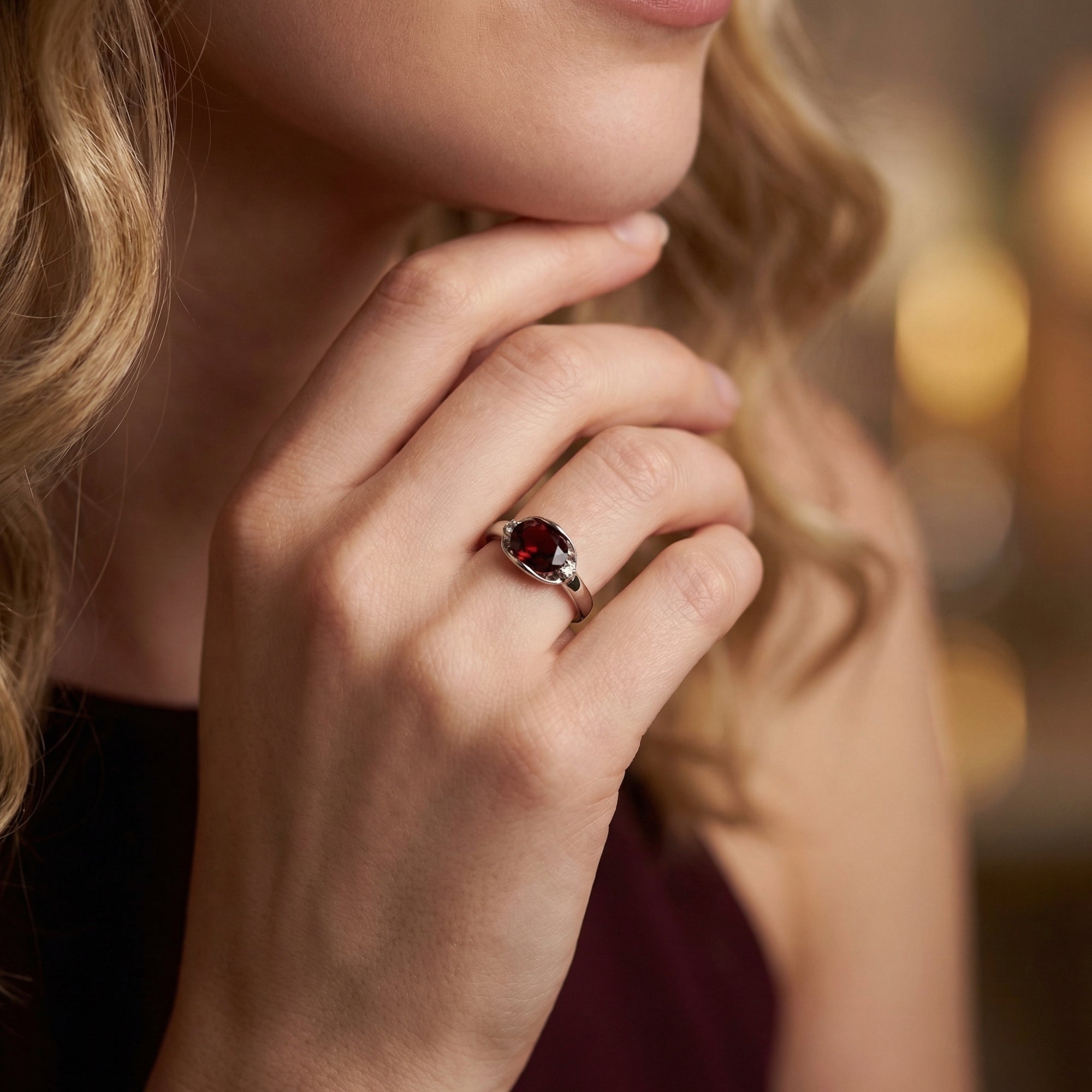 Woman wearing the Florenza sterling silver statement ring with a large oval natural garnet.