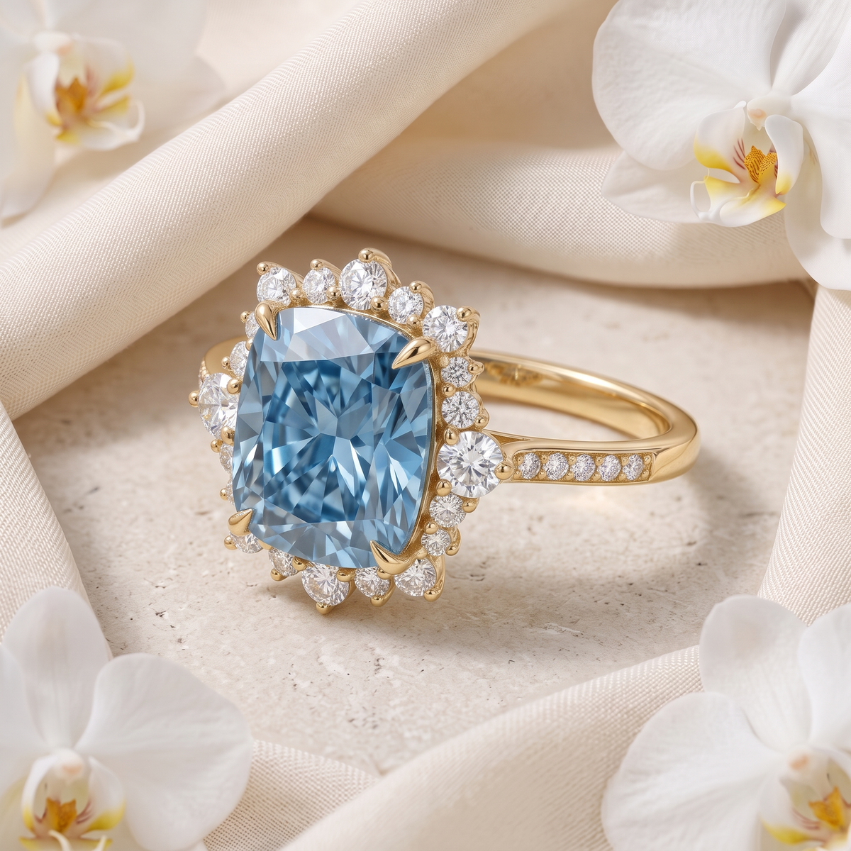 Angled view of a yellow gold cushion-cut blue moissanite ring on silk fabric.