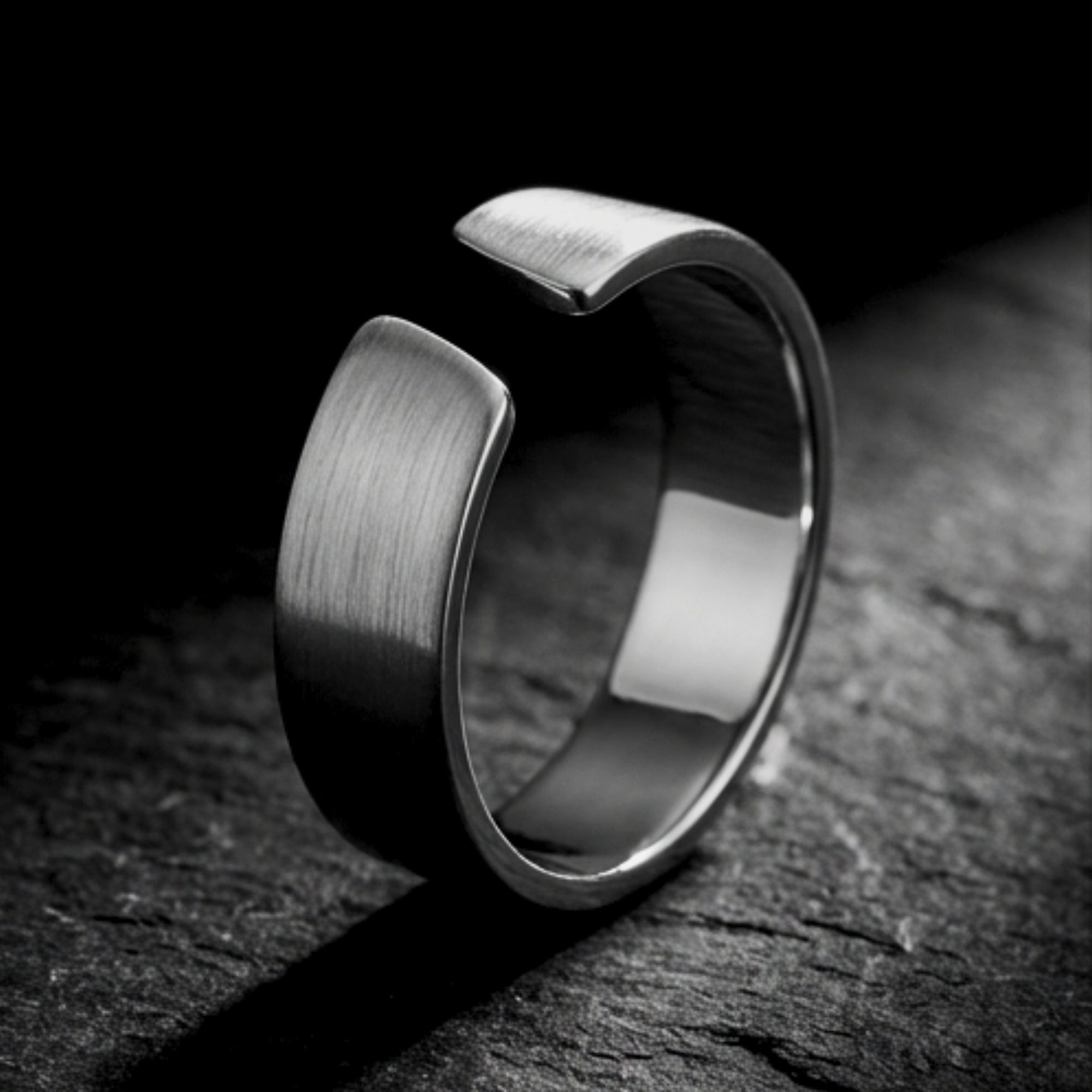 Macro view of the brushed silver stainless steel Spartan band ring highlighting the open gap and matte texture.