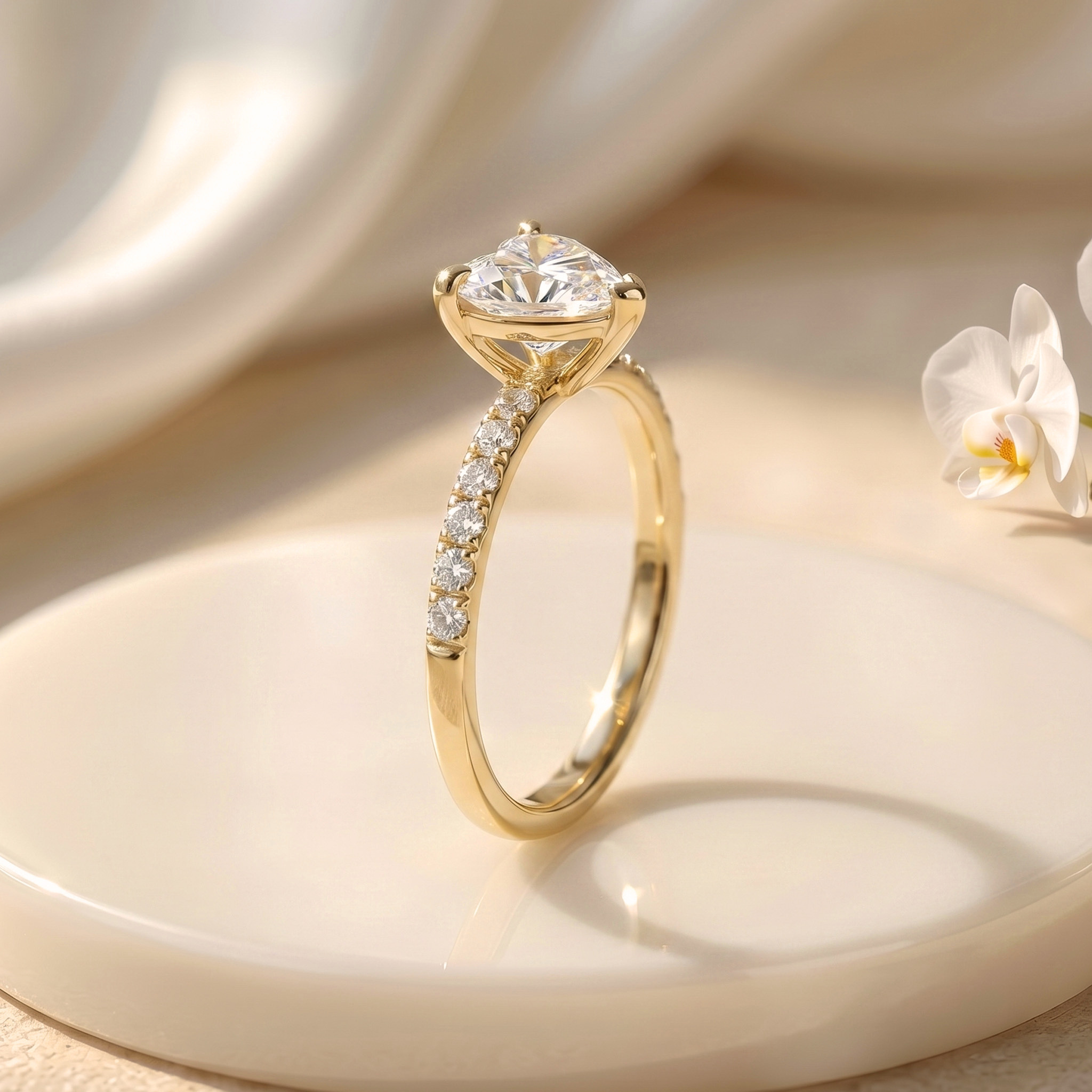 A side profile of the yellow gold heart-shaped moissanite ring, highlighting the detailed setting and diamond-encrusted band.
