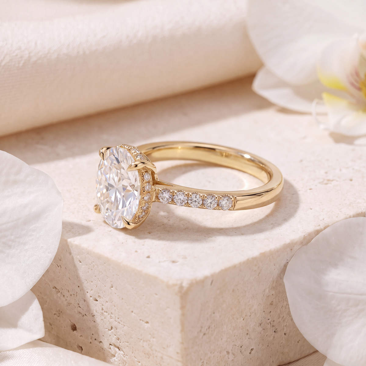 Side-profile view of the yellow gold oval moissanite engagement ring showcasing the hidden halo detail.