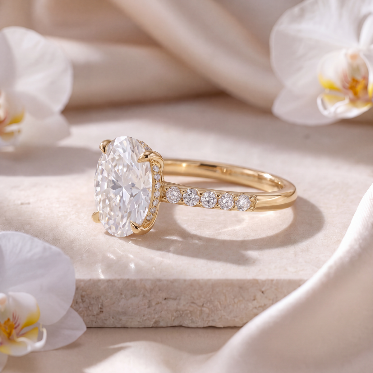 Side view of a gold oval moissanite engagement ring featuring a hidden halo and pavé band.