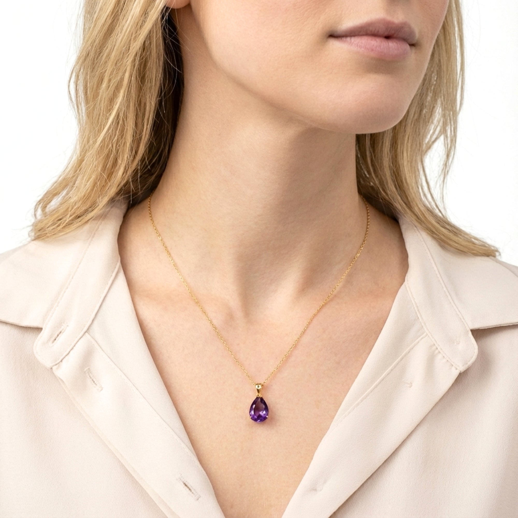 Model wearing the Vesperia teardrop cut simulated amethyst pendant necklace in 18K gold vermeil.