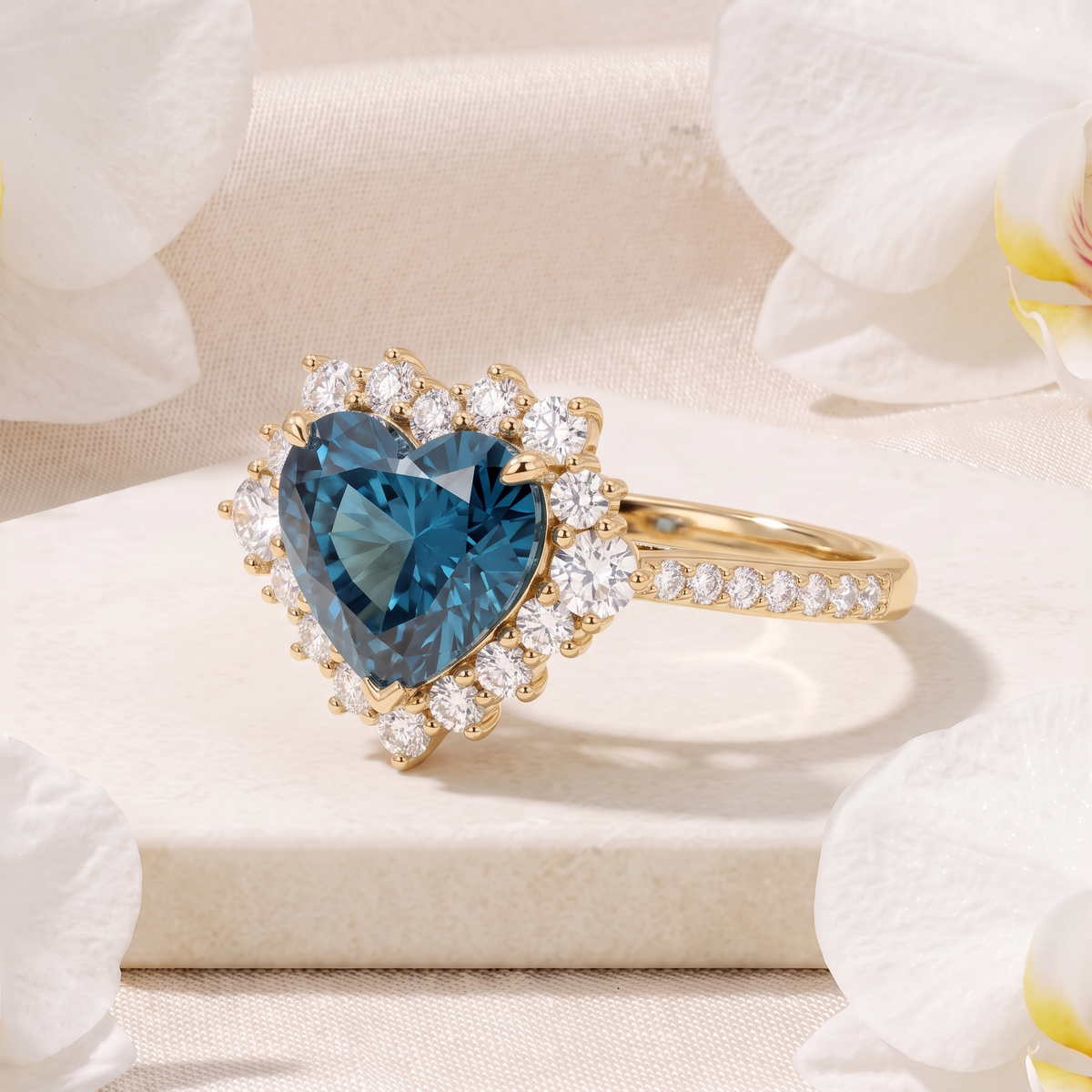 Angled side view of a yellow gold halo ring with a heart-shaped teal blue center stone.