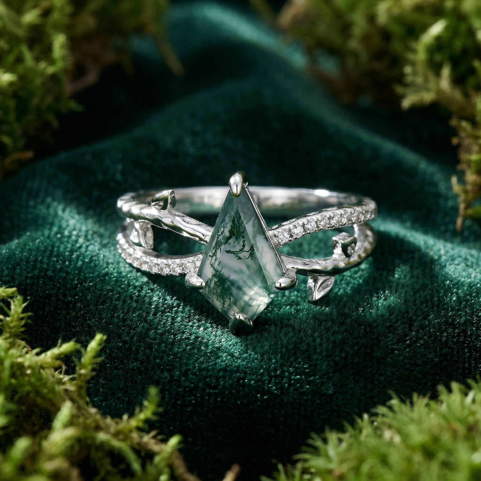 Detailed view of a kite cut moss agate and diamond embrace ring in S925 sterling silver.