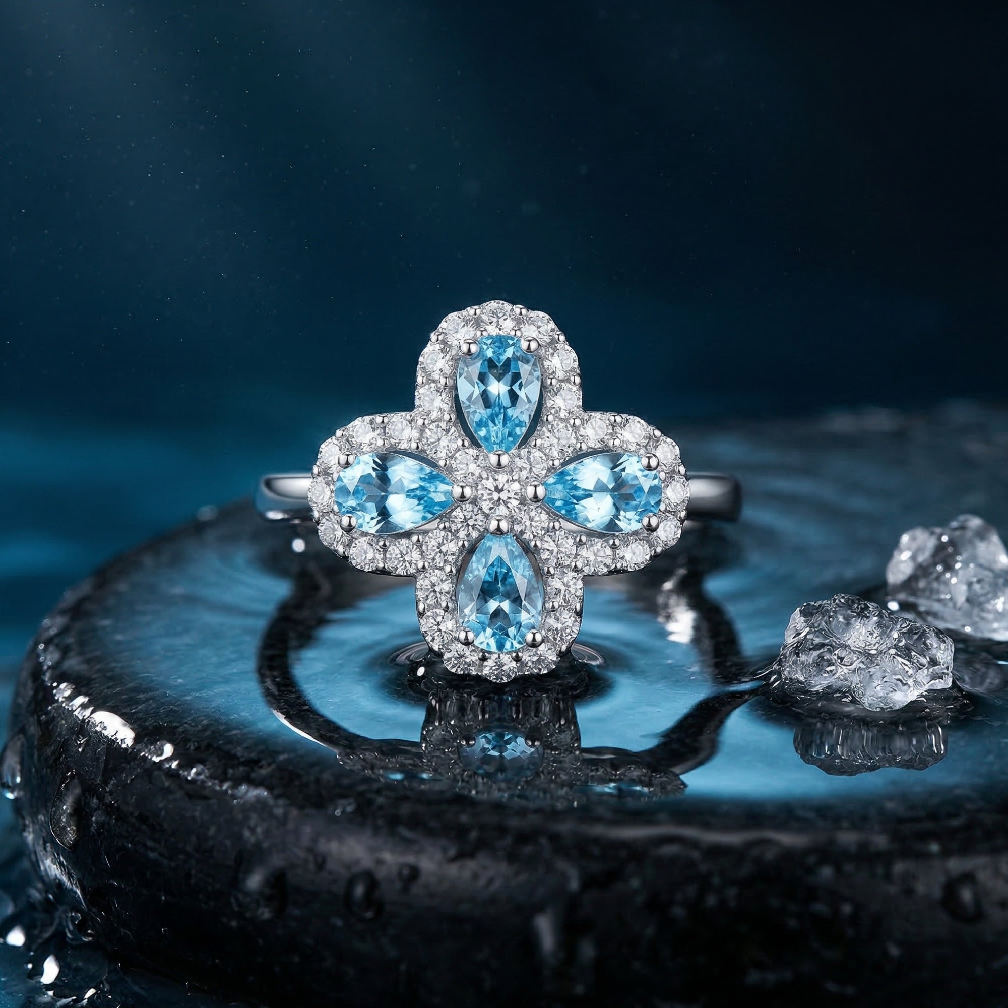 Close-up of the pear-cut natural aquamarine clover ring in sterling silver with a sparkling halo.