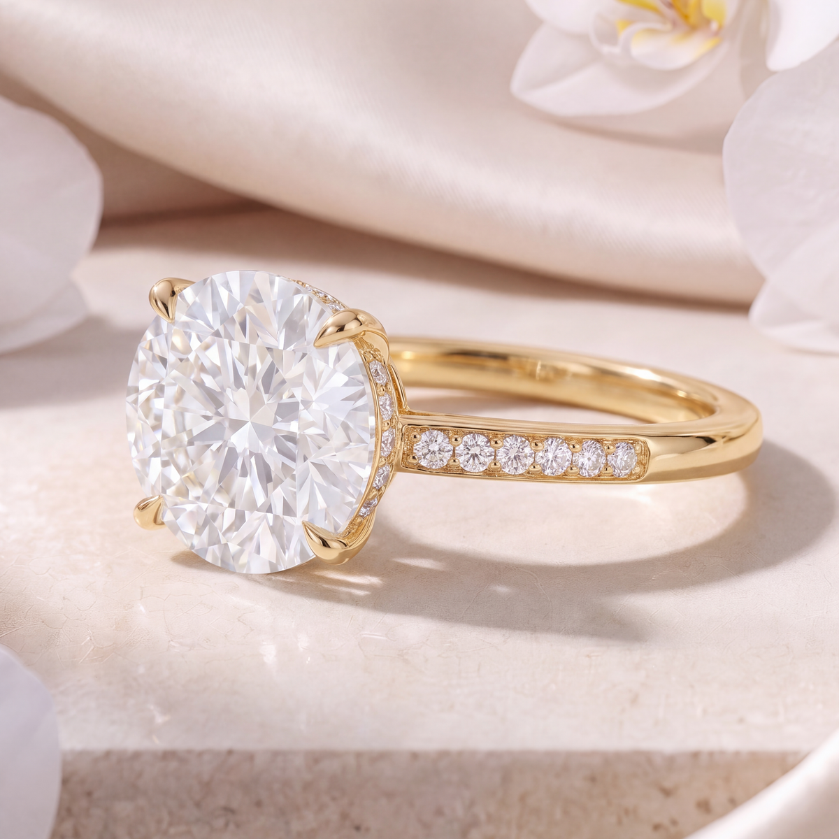 Angled side profile of a yellow gold round moissanite ring featuring a hidden halo and pavé band.
