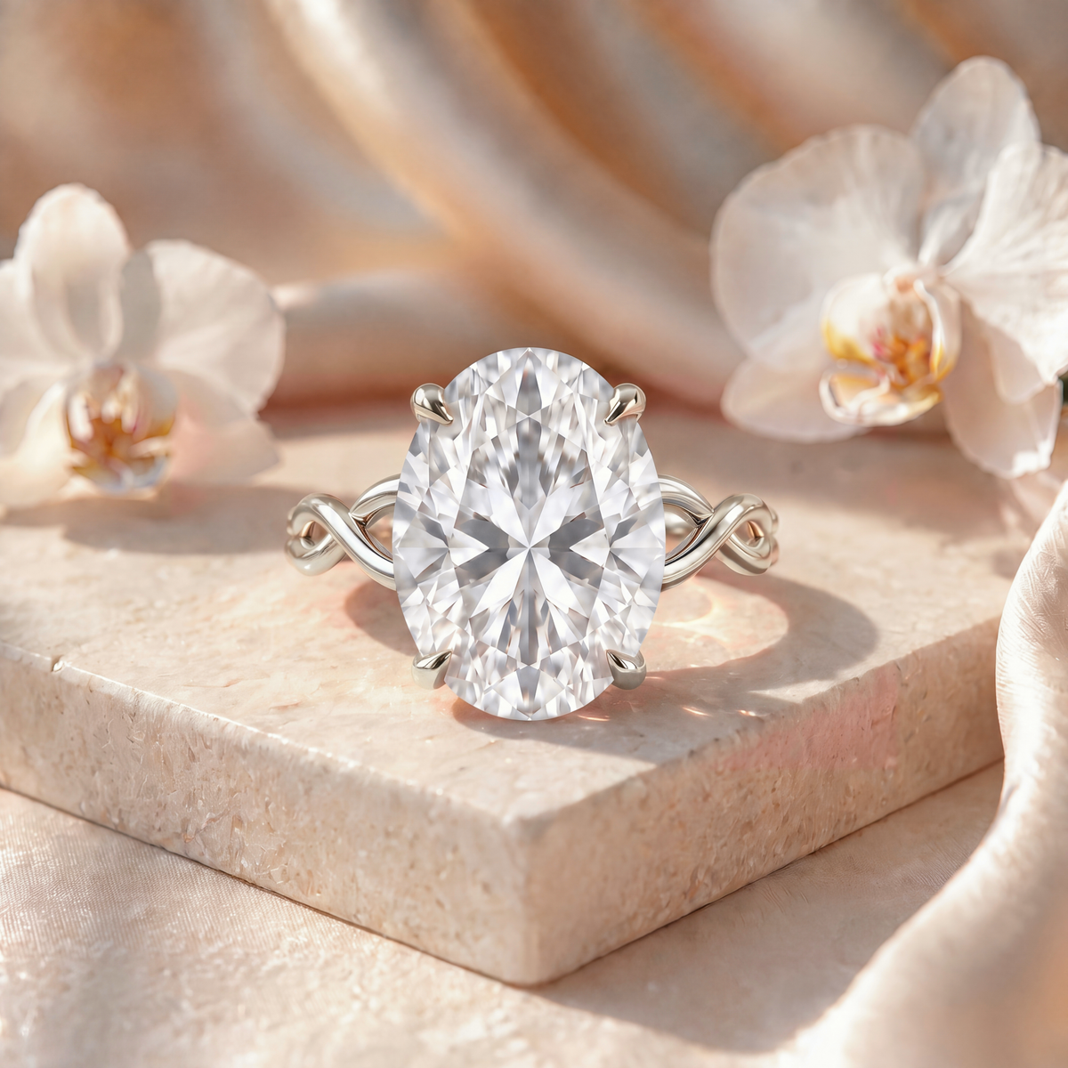 An oval-cut moissanite engagement ring with a twisted white gold band on a stone block.