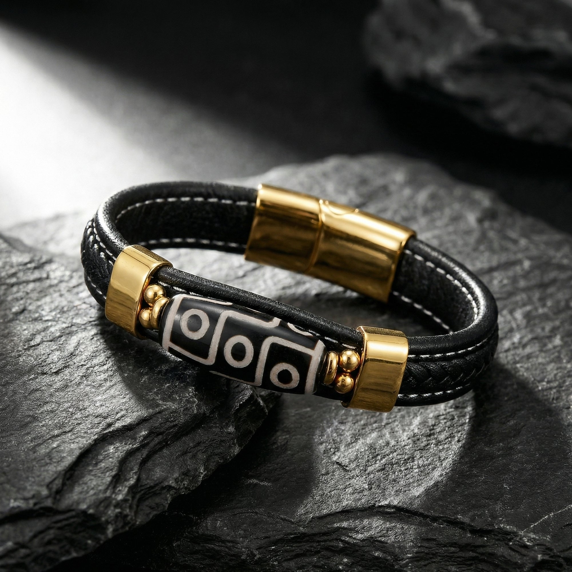 Close-up of the Enigma bracelet featuring gold PVD stainless steel hardware and a geometric centerpiece.
