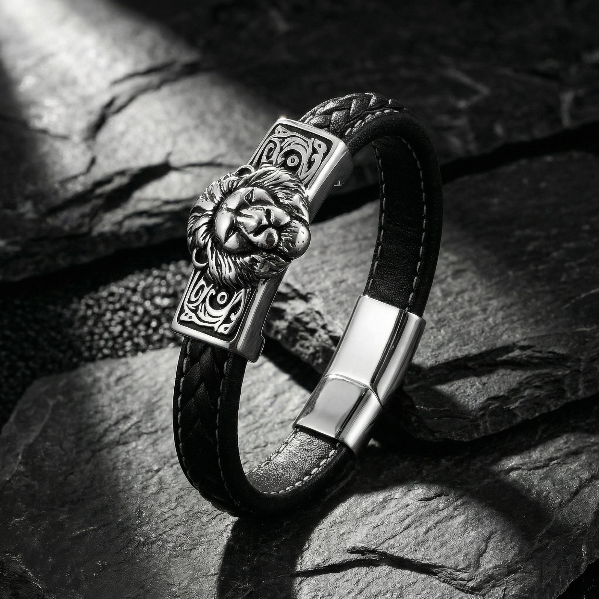 Angled view of the black leather lion bracelet showing the silver stainless steel magnetic clasp on stone.