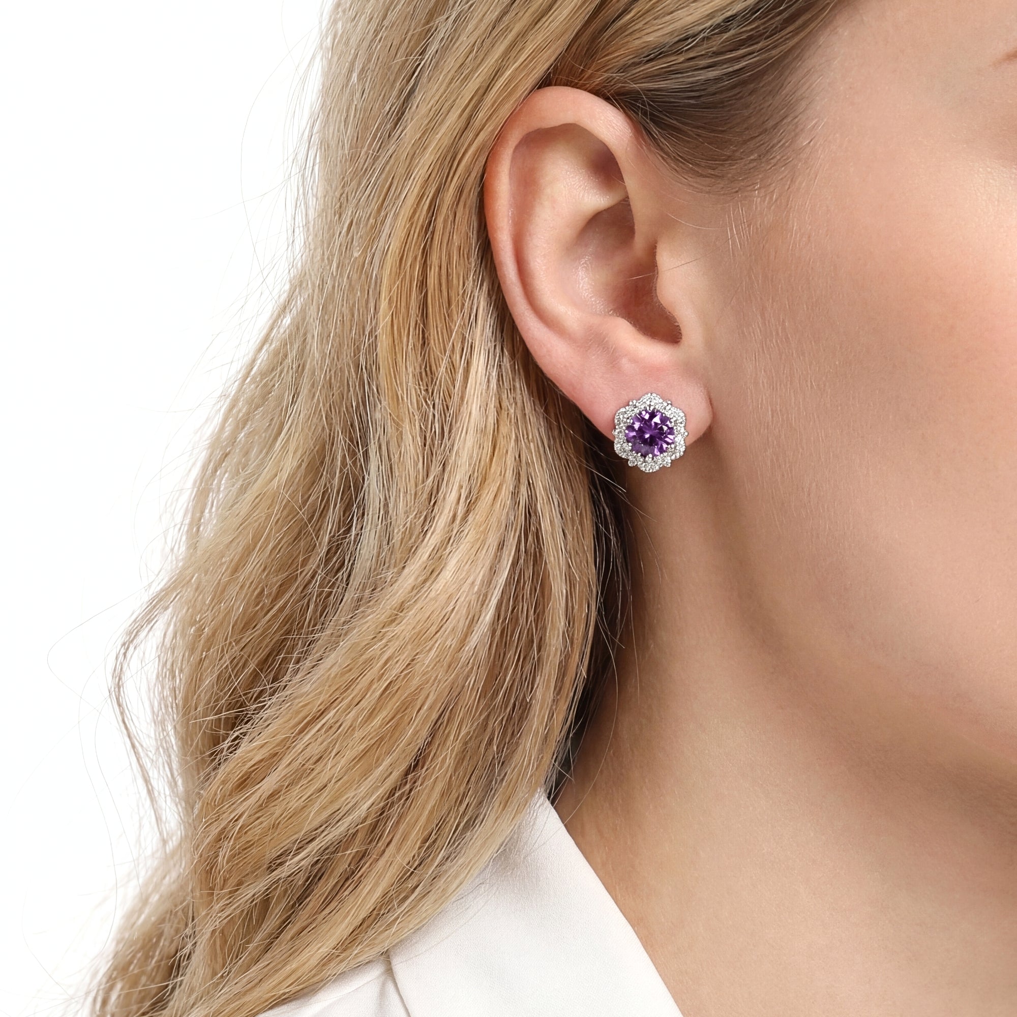Model wearing a round cut simulated amethyst floral halo stud earring in S925 sterling silver on her ear.