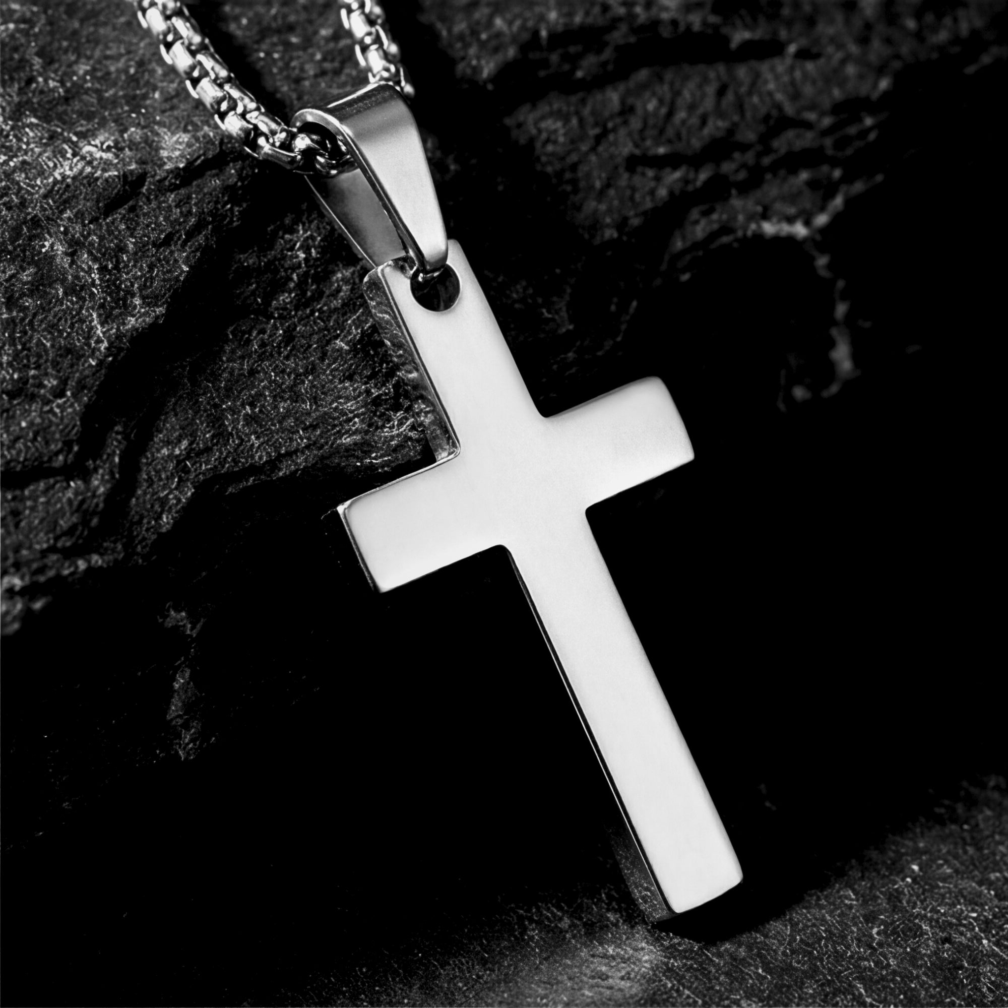 Close-up of the polished silver stainless steel Apostle Cross pendant showing the smooth finish and bail detail.