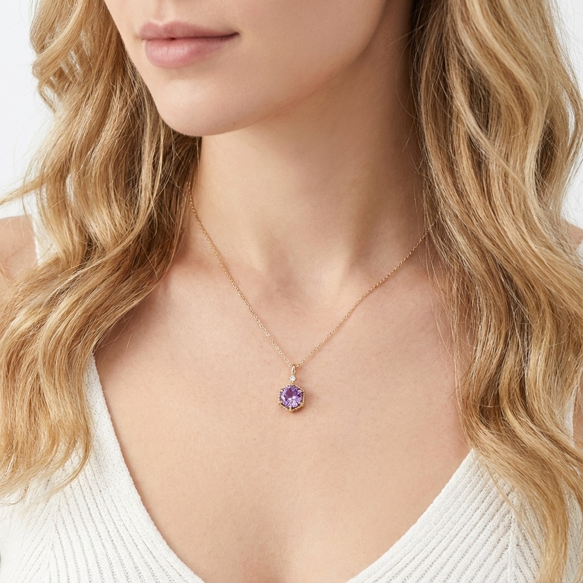 Model wearing the Hesperia 18K gold vermeil necklace with a purple simulated amethyst pendant, front view.