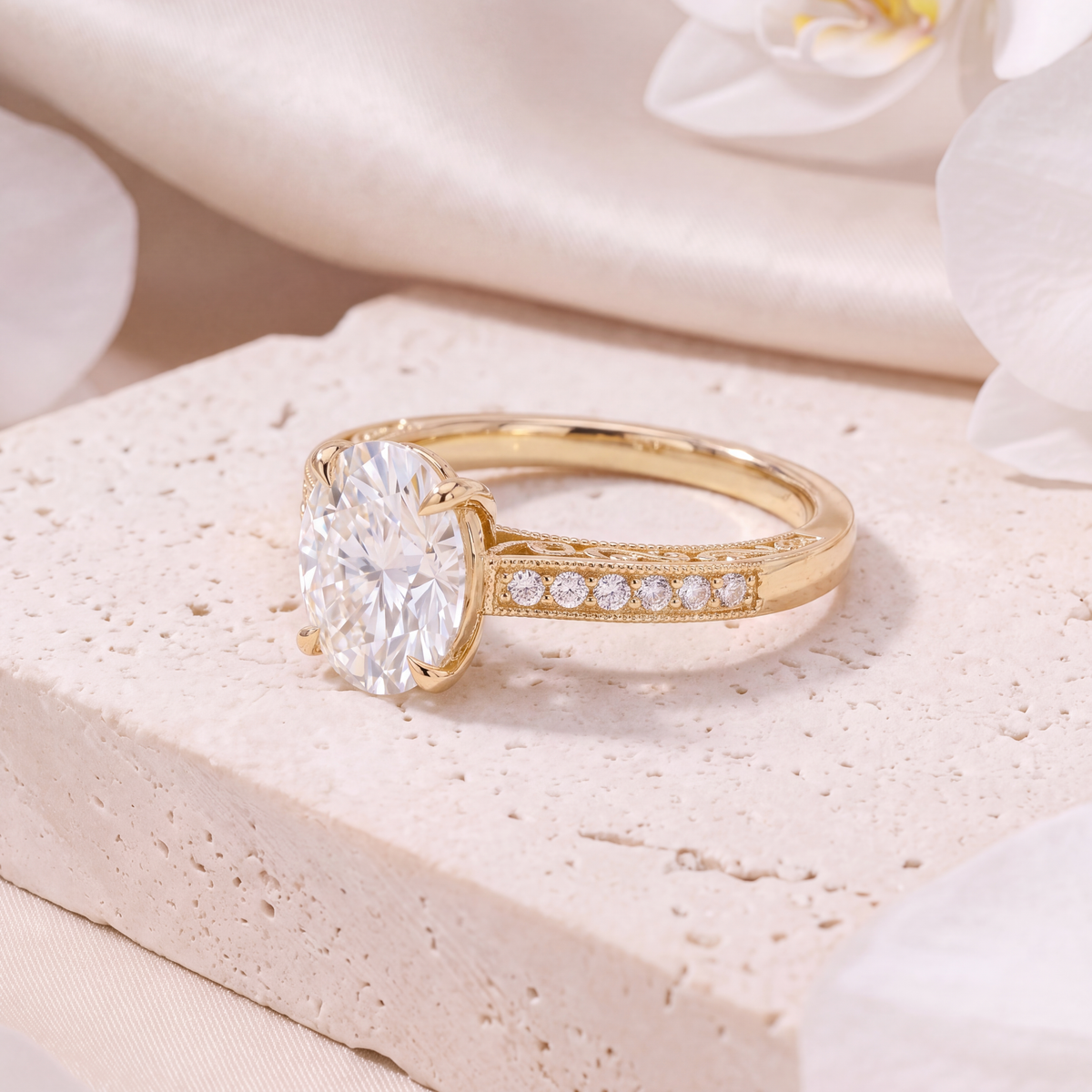 Side view of a yellow gold oval moissanite ring highlighting the detailed vintage-inspired band.