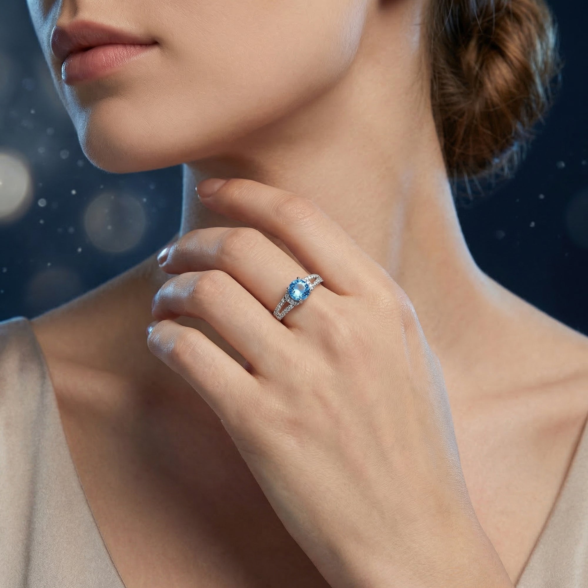 Model wearing the Azurella natural topaz sterling silver ring, highlighting the vibrant blue center stone.
