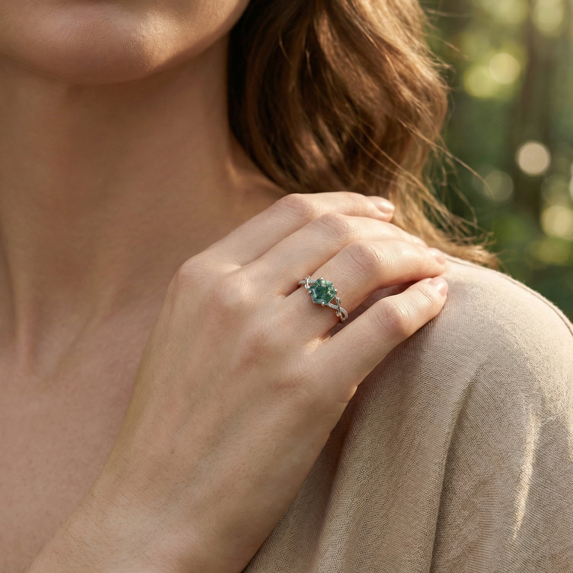 A woman wearing the hexagonal moss agate ring on her finger, showcasing the unique green stone inclusions.