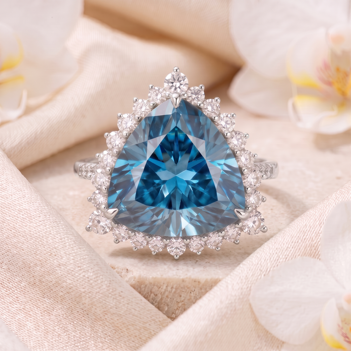 Front view of a trillion-cut blue moissanite halo ring in white gold.