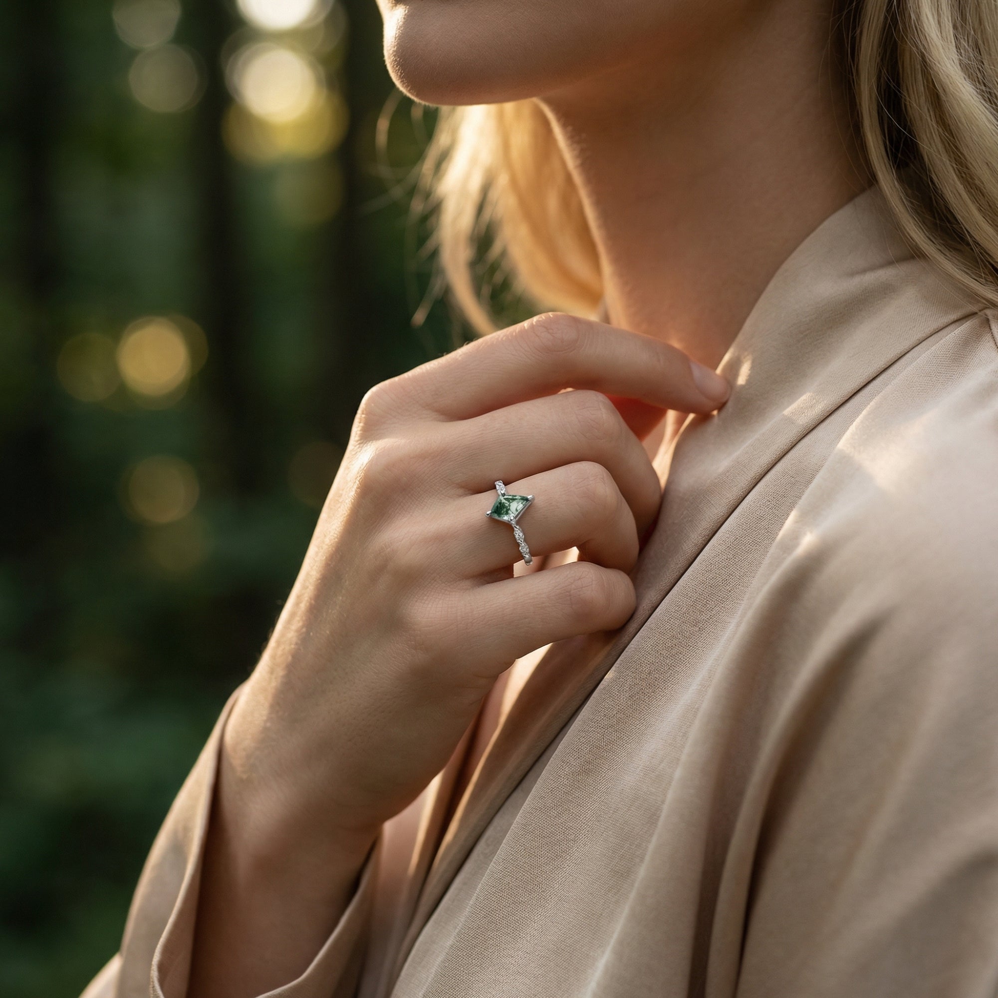 Sterling silver kite cut moss agate ring with diamond accents worn on a model's hand in natural light.