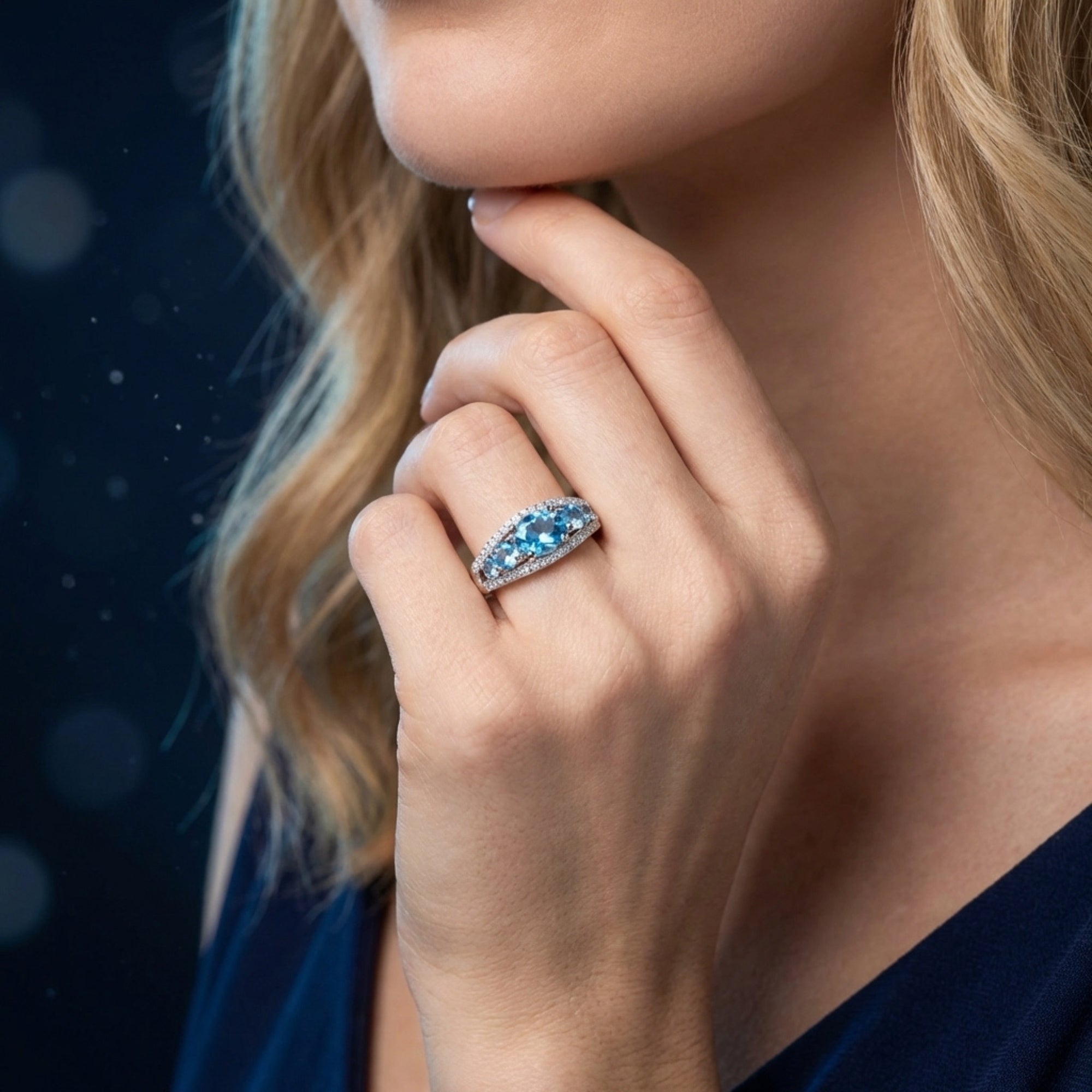 Lifestyle view of a model wearing the Nereida Swiss blue topaz ring in sterling silver.