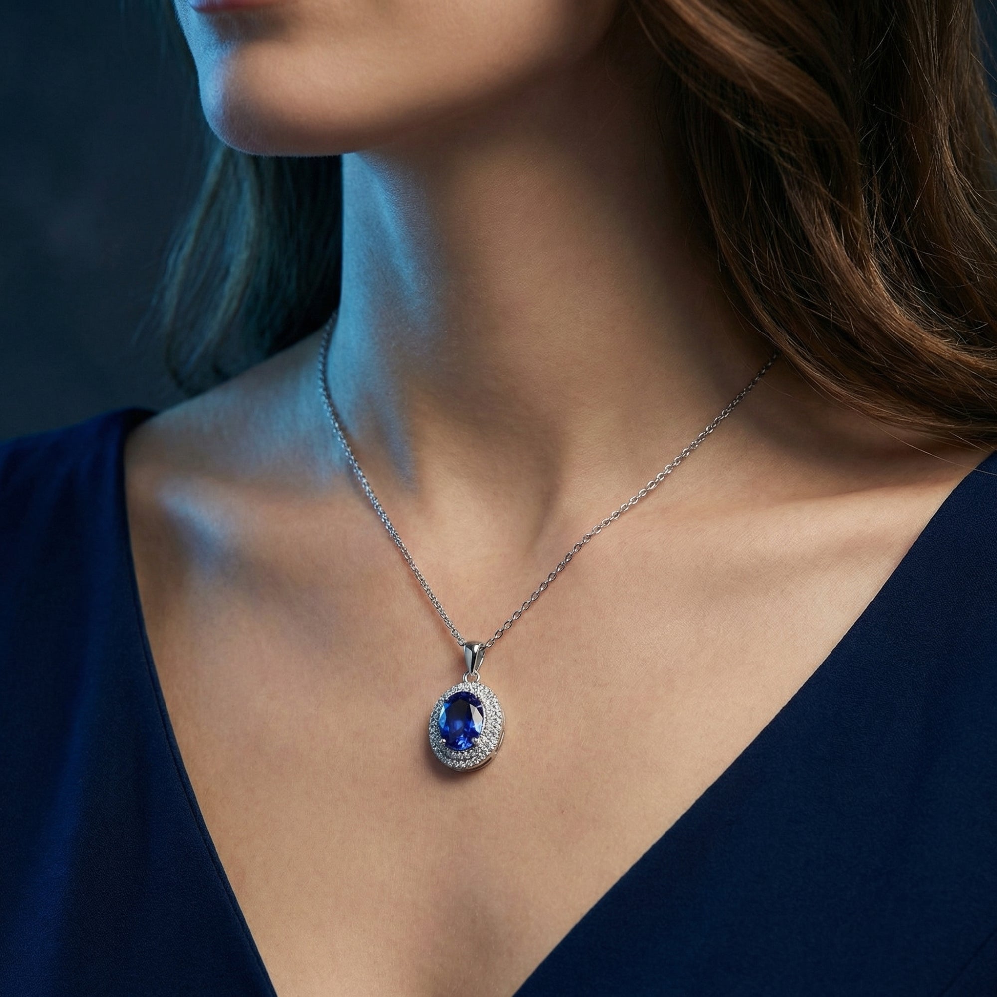 A woman wearing the oval tanzanite and zircon halo pendant on a sterling silver chain.