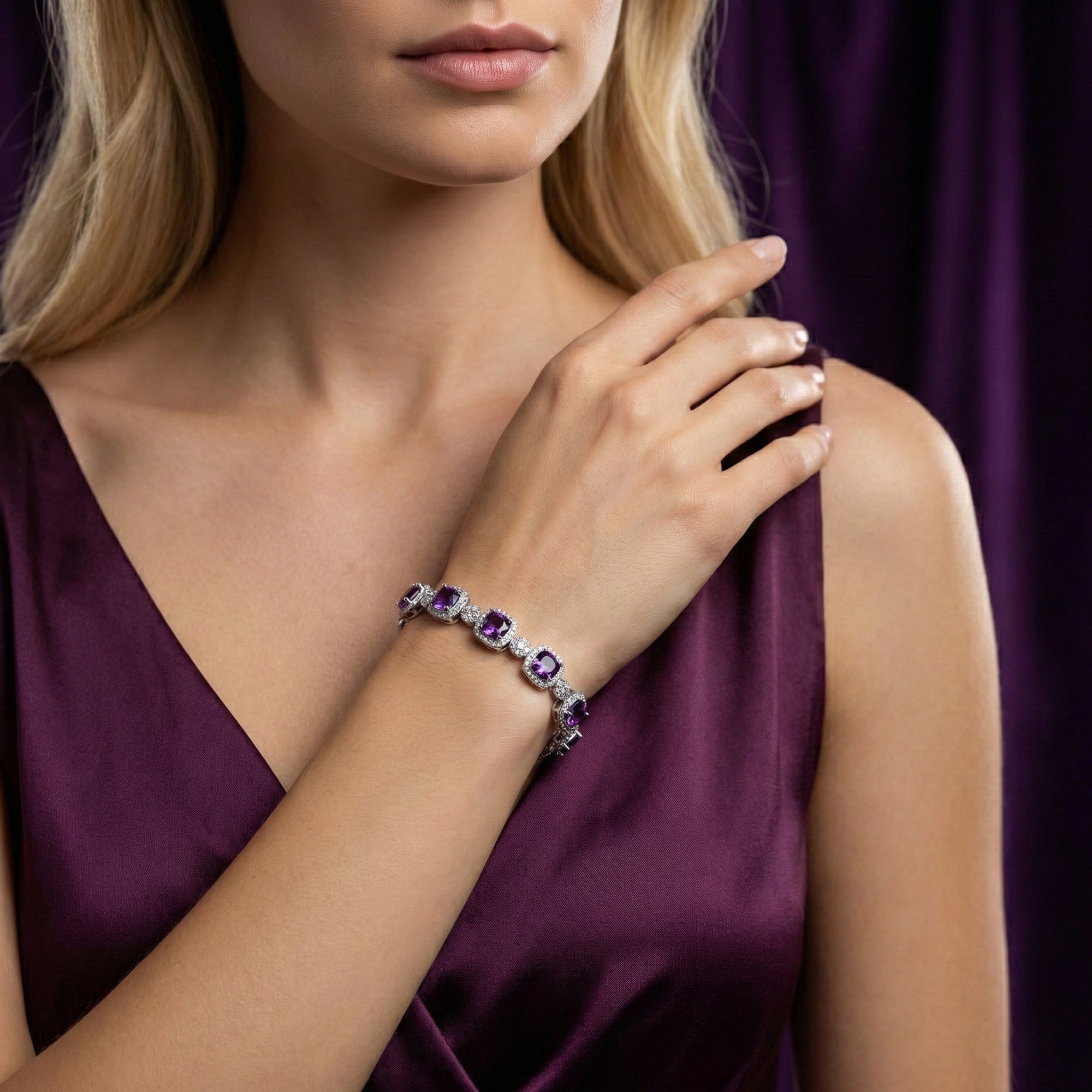 Sterling silver bracelet with cushion cut amethyst stones worn on a woman's wrist against a purple background.