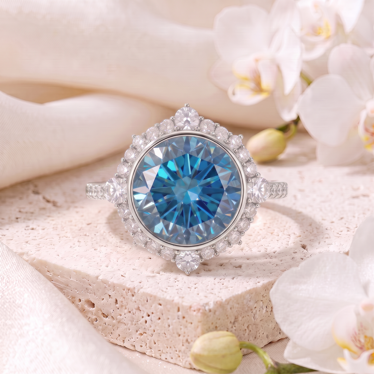 Round blue moissanite halo engagement ring in white gold on a stone display.