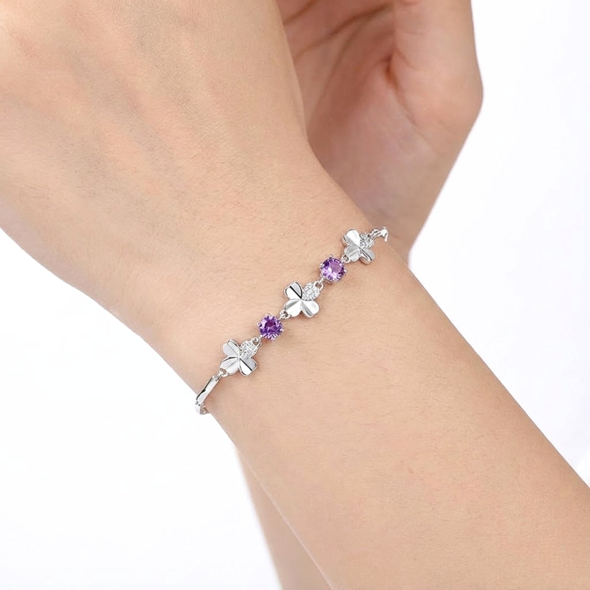 Close-up of the sterling silver Amoret bracelet with precision-cut purple simulated amethyst on a woman's wrist.