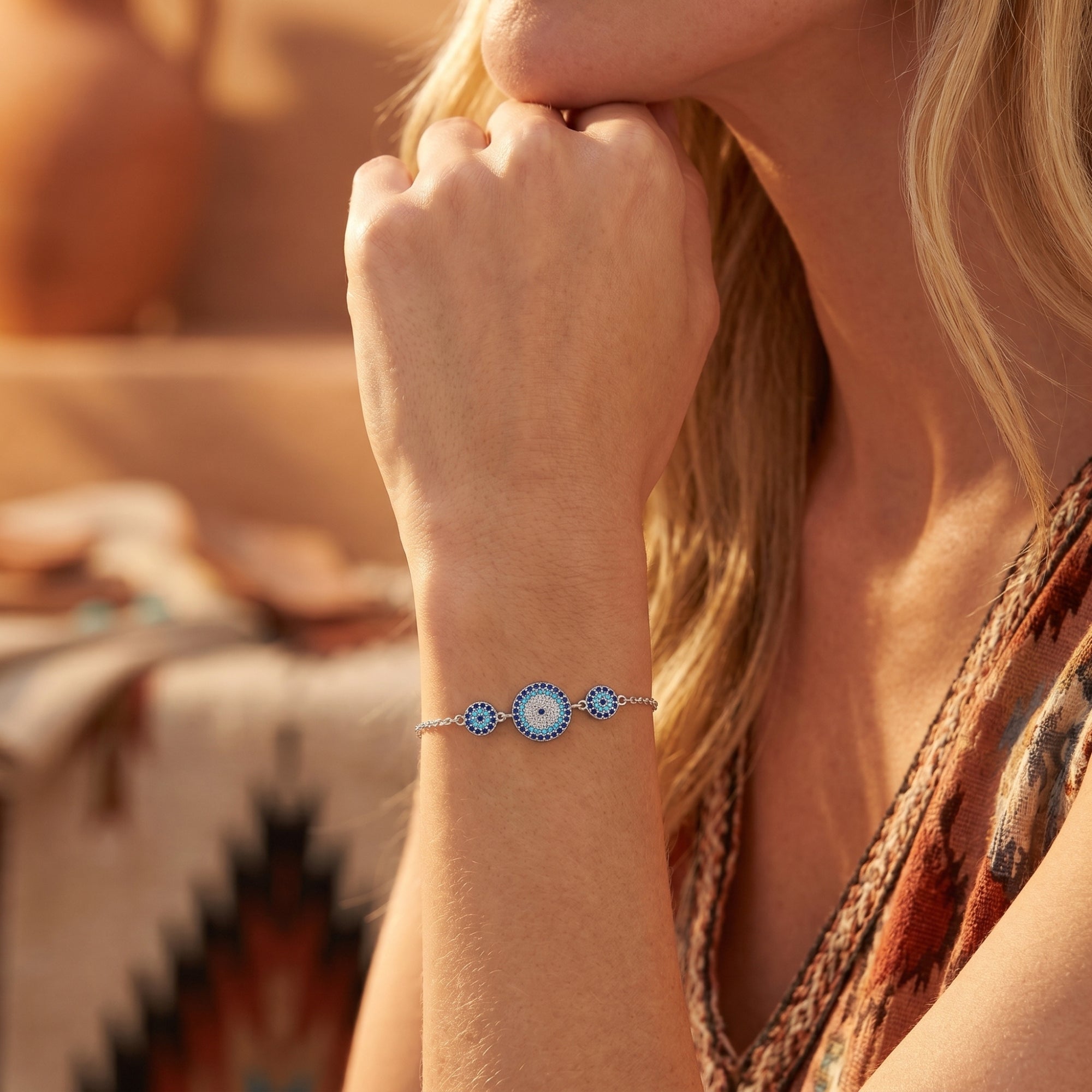 Silver Paloma turquoise bracelet with three circular stations worn by a model in a sunlit desert landscape.