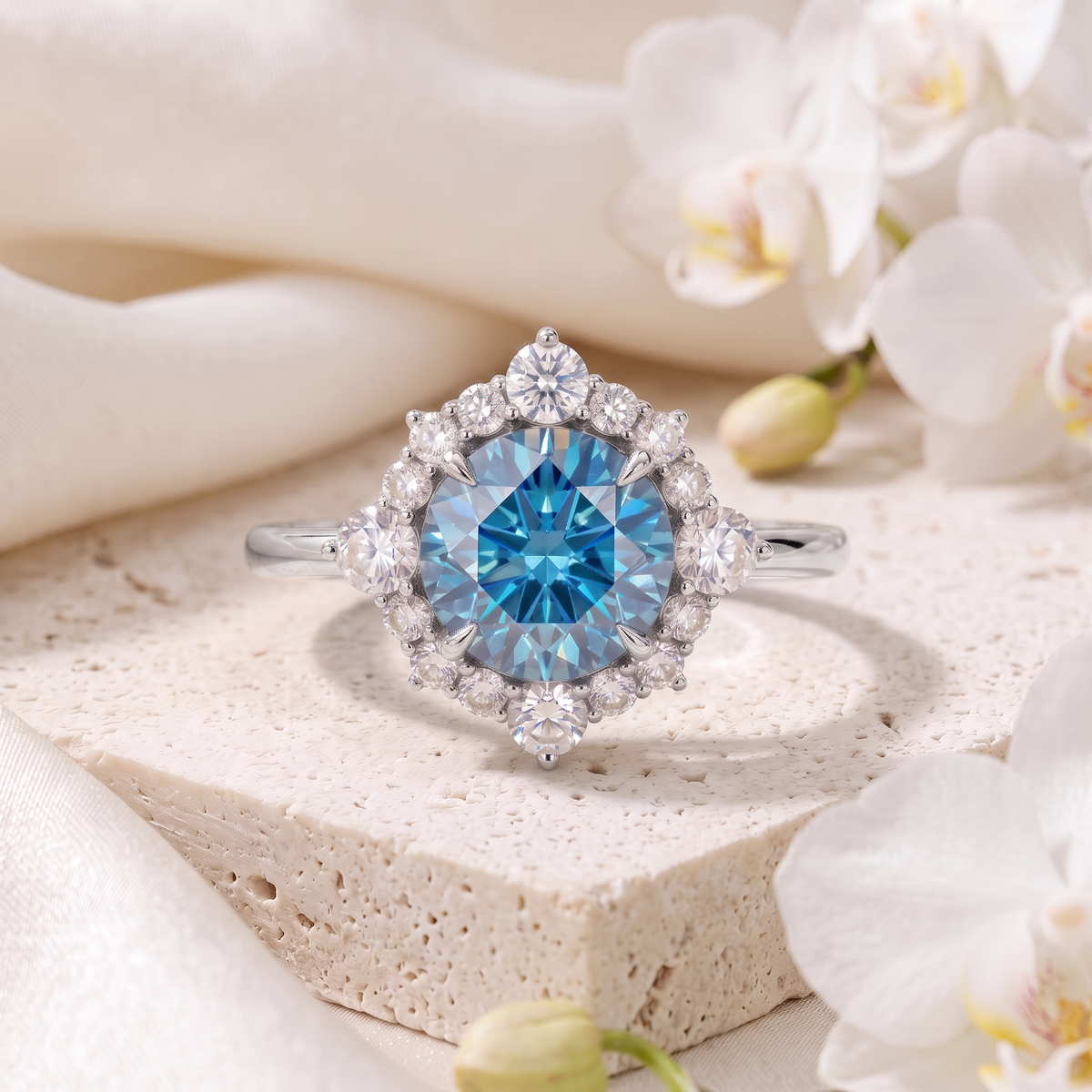 Front view of a round blue moissanite halo engagement ring in white gold.